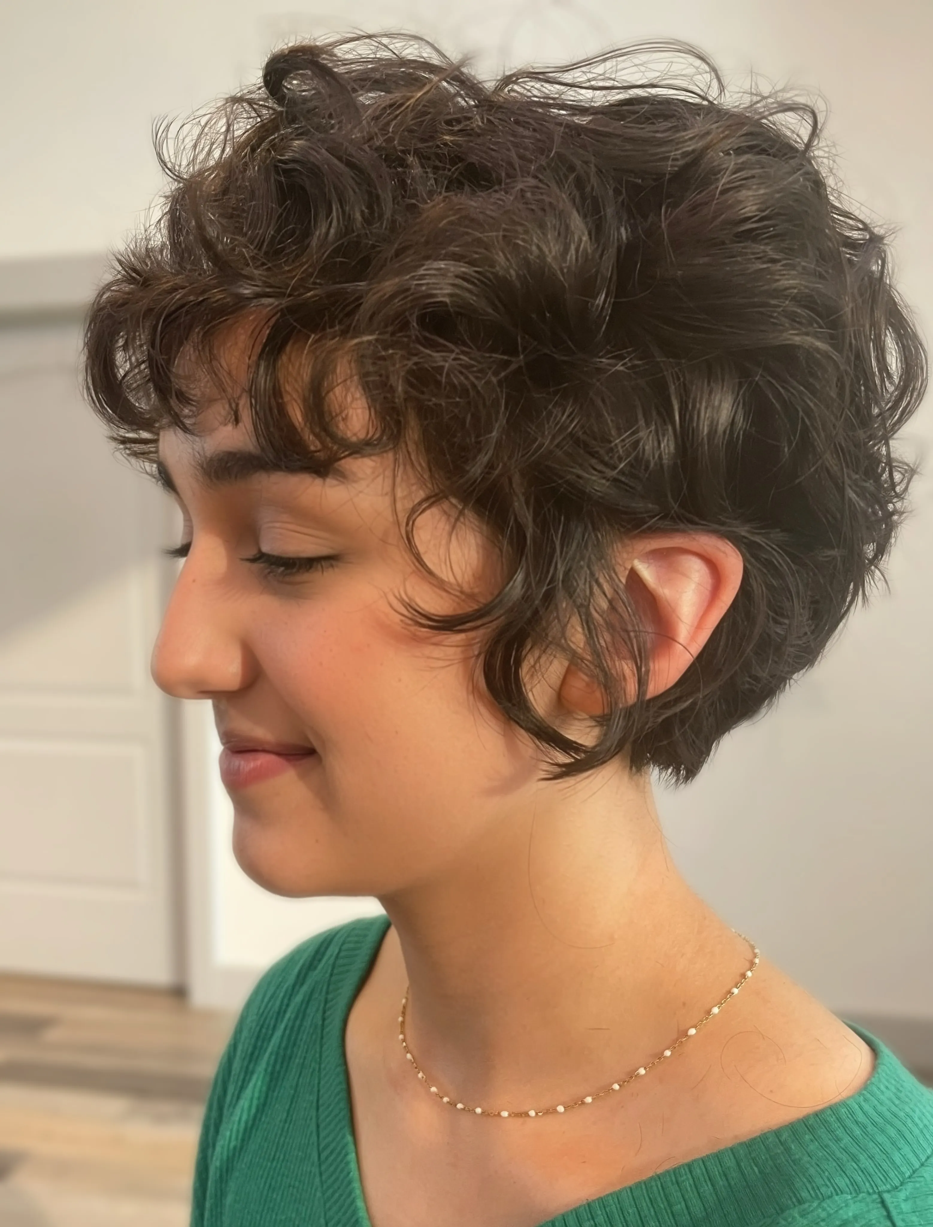 Sculpted curl bixie with tapered nape and longer face pieces