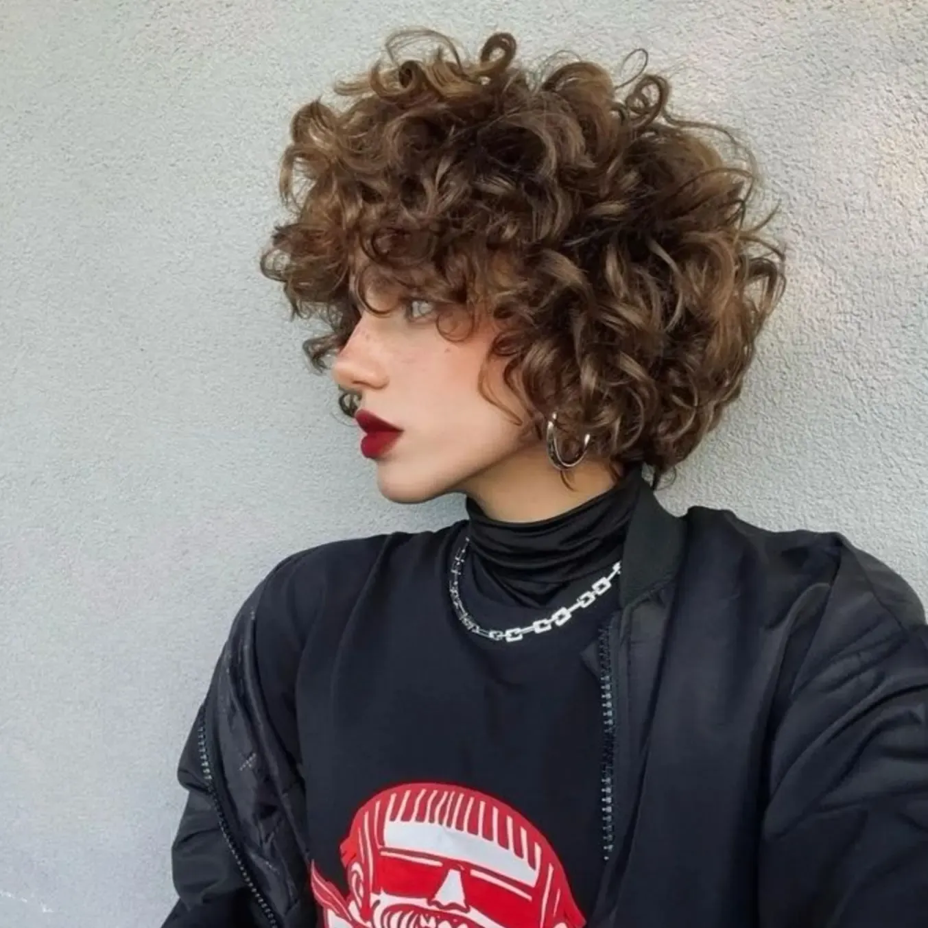 Rounded ringlet bixie with full curly fringe and dense volume