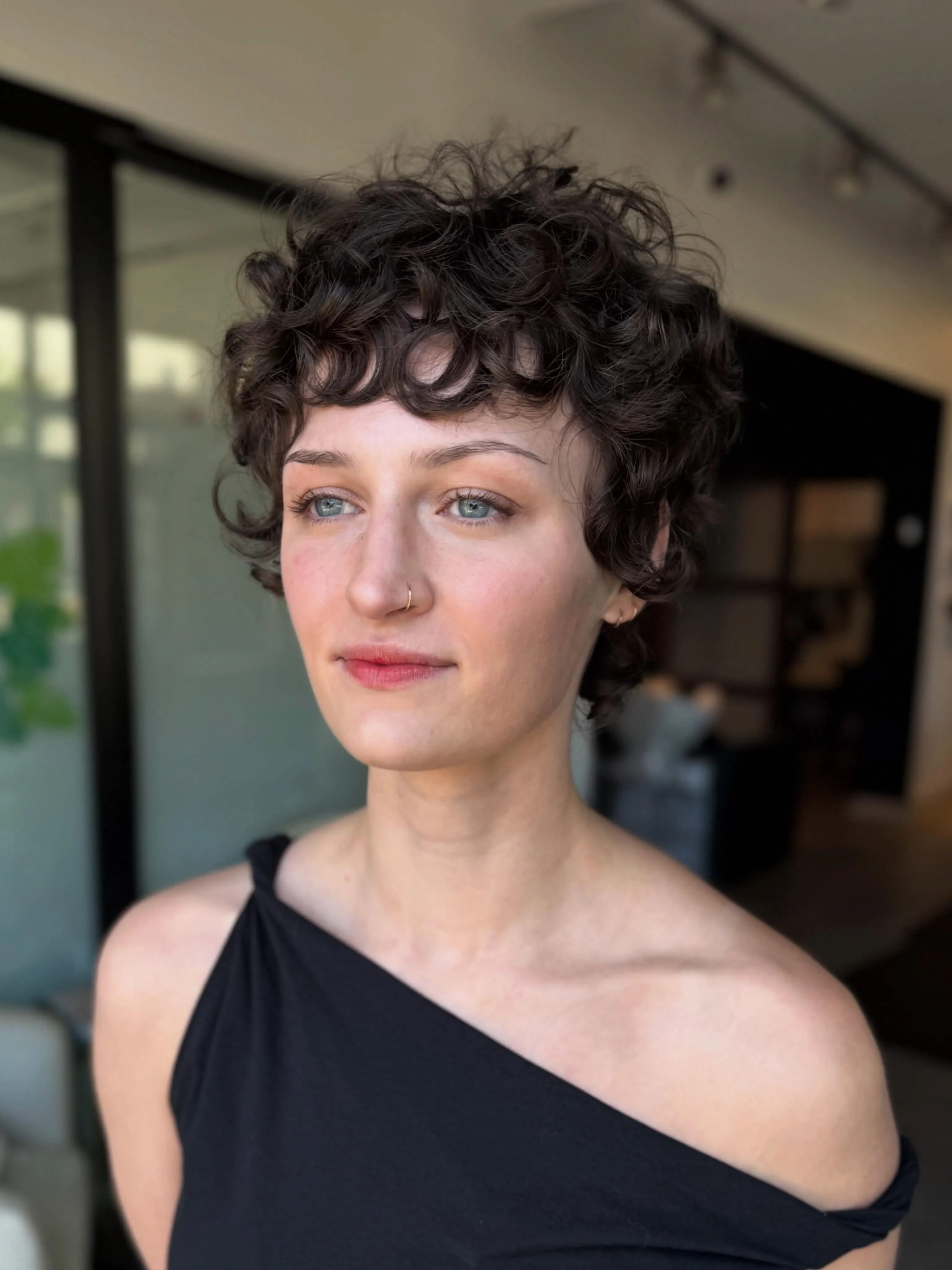 Cropped curl bixie with short sides and compact curls
