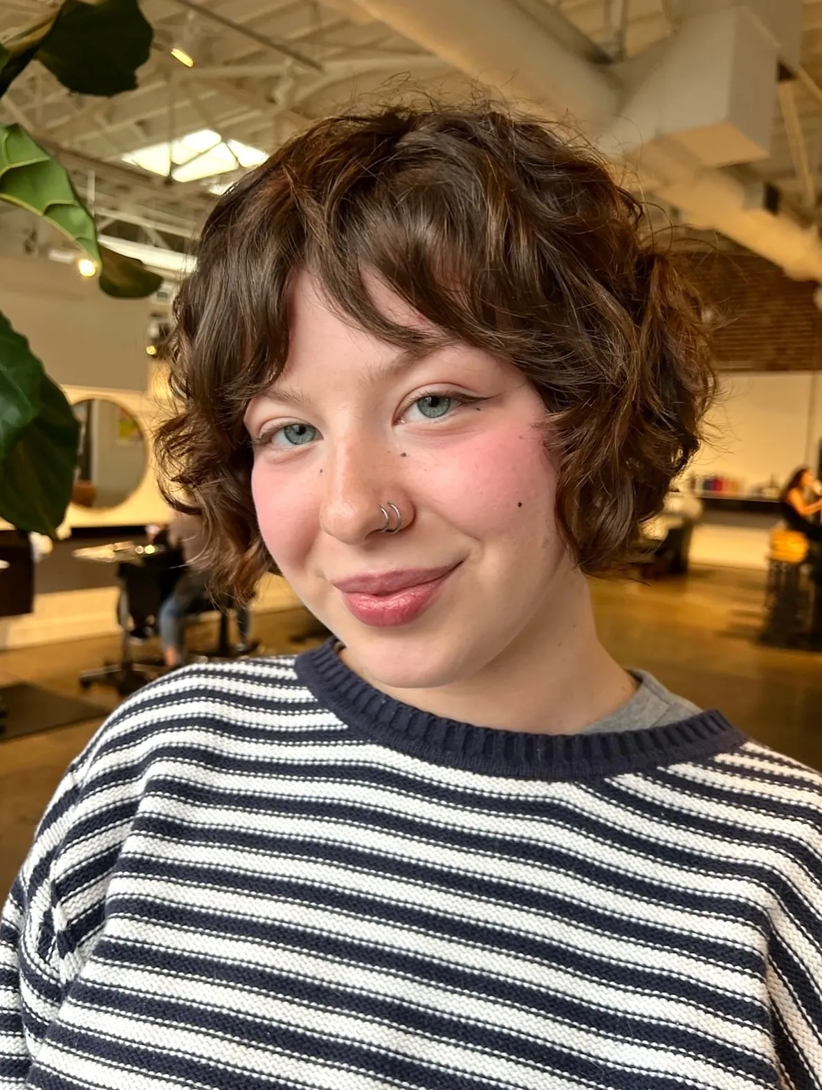 Soft wavy bixie with side-swept fringe and rounded ends