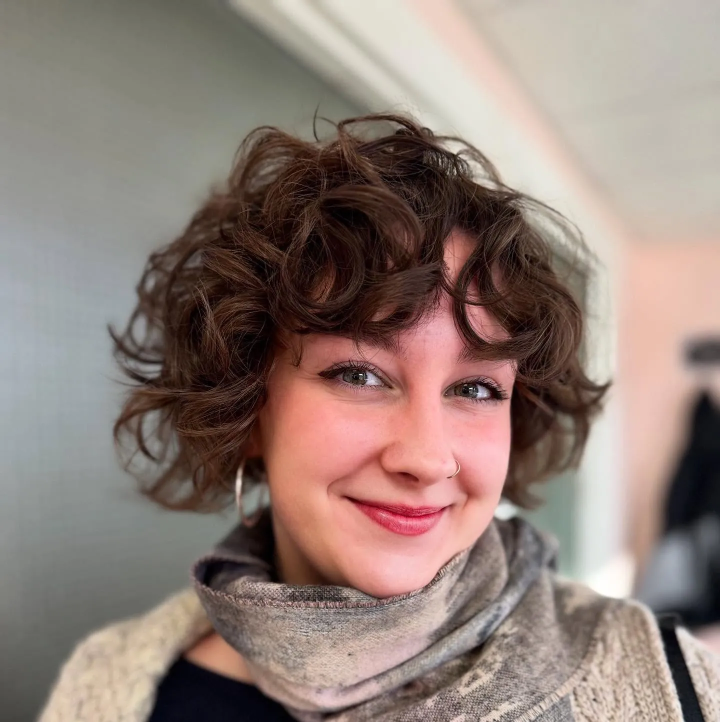 Tousled curl bixie with airy layers and curved fringe