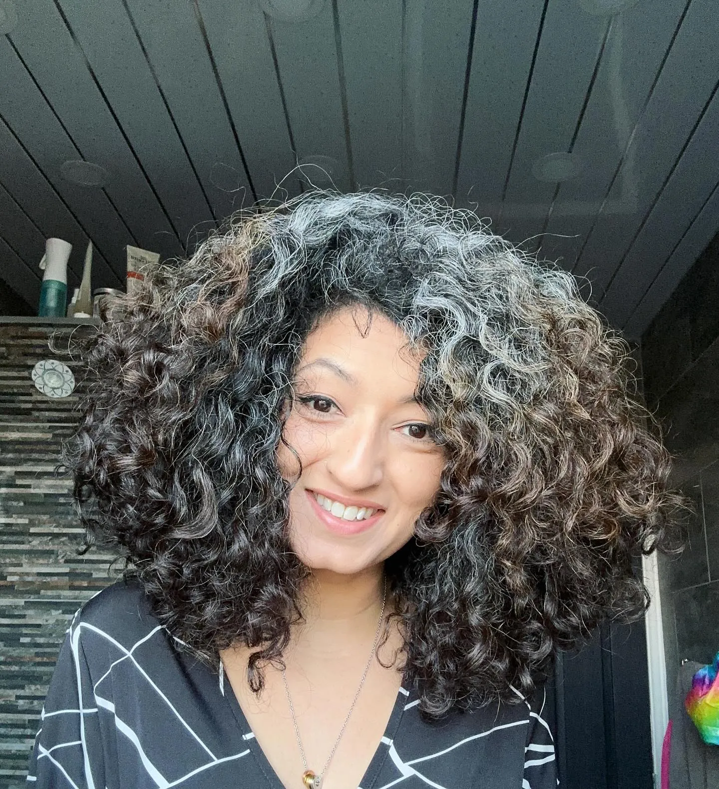 Full dark curly lob with defined volume