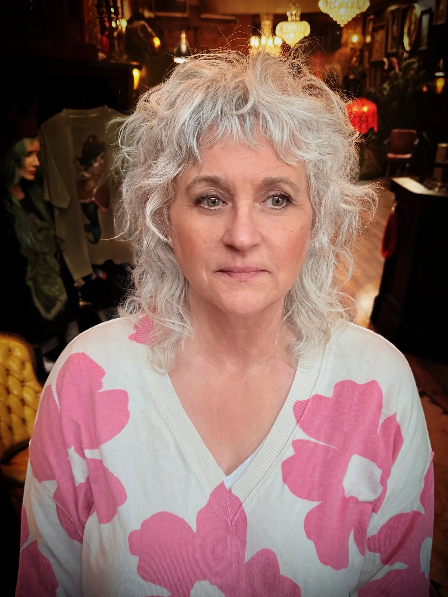Short silver curly shag with wispy fringe and longer nape