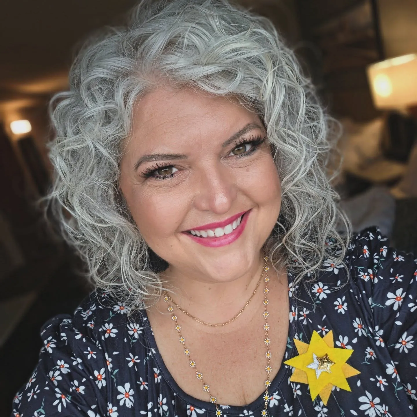 Short silver curly bob with a deep side part
