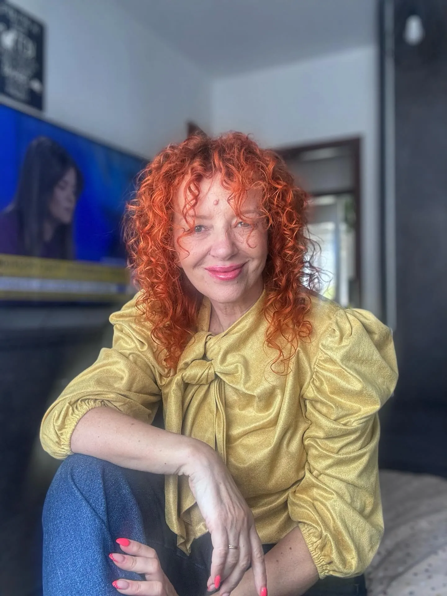 Shoulder-length red curls with a short curly fringe