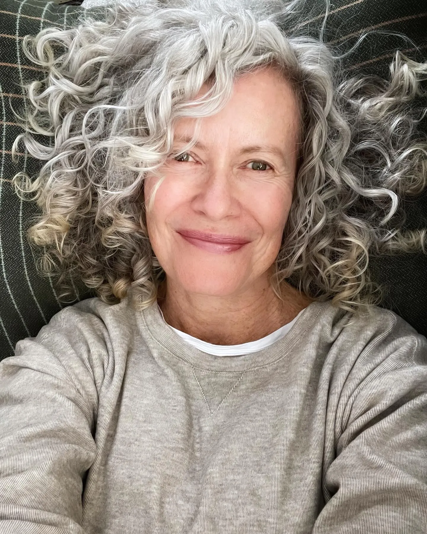 Shoulder-length silver ringlets with a soft side part
