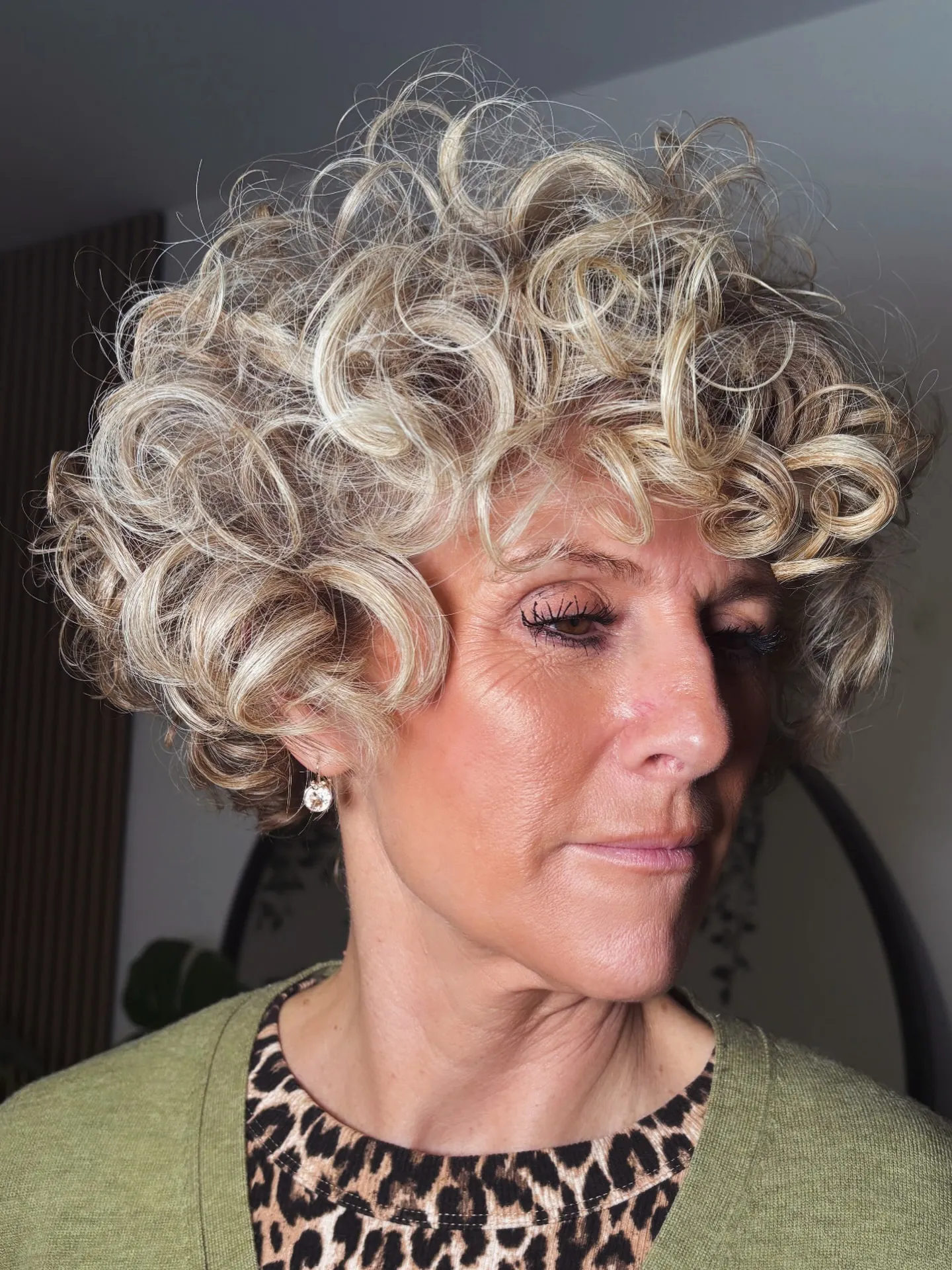 Short silver curly crop with soft face-framing curls