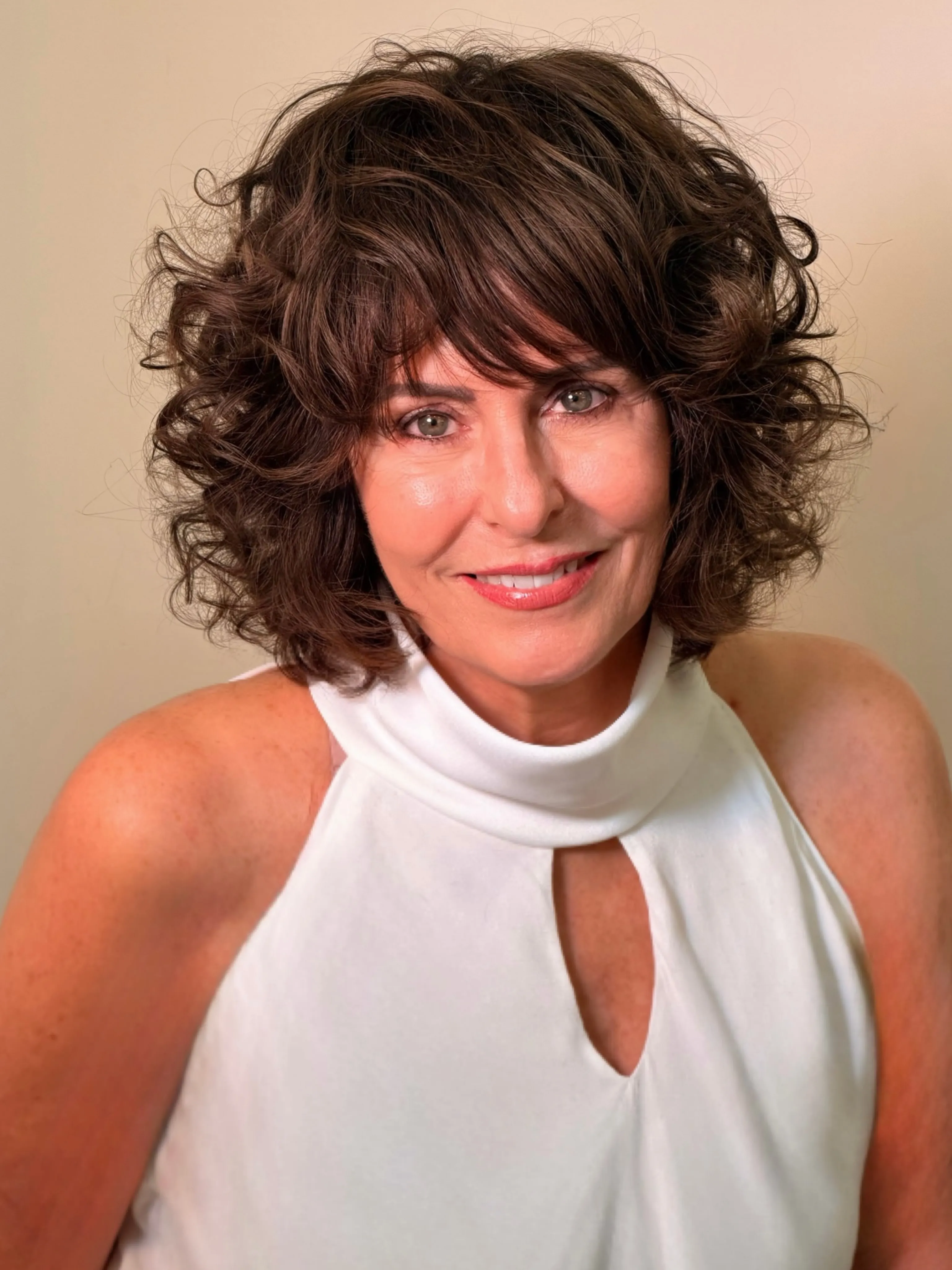 Dark curly bob with side-swept bangs