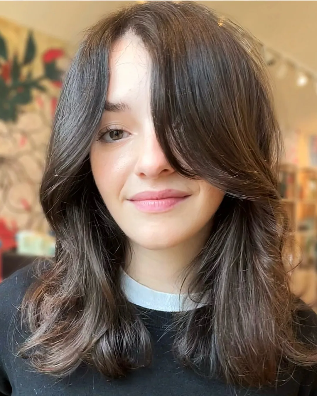 Brunette shoulder-length curve cut with rounded ends