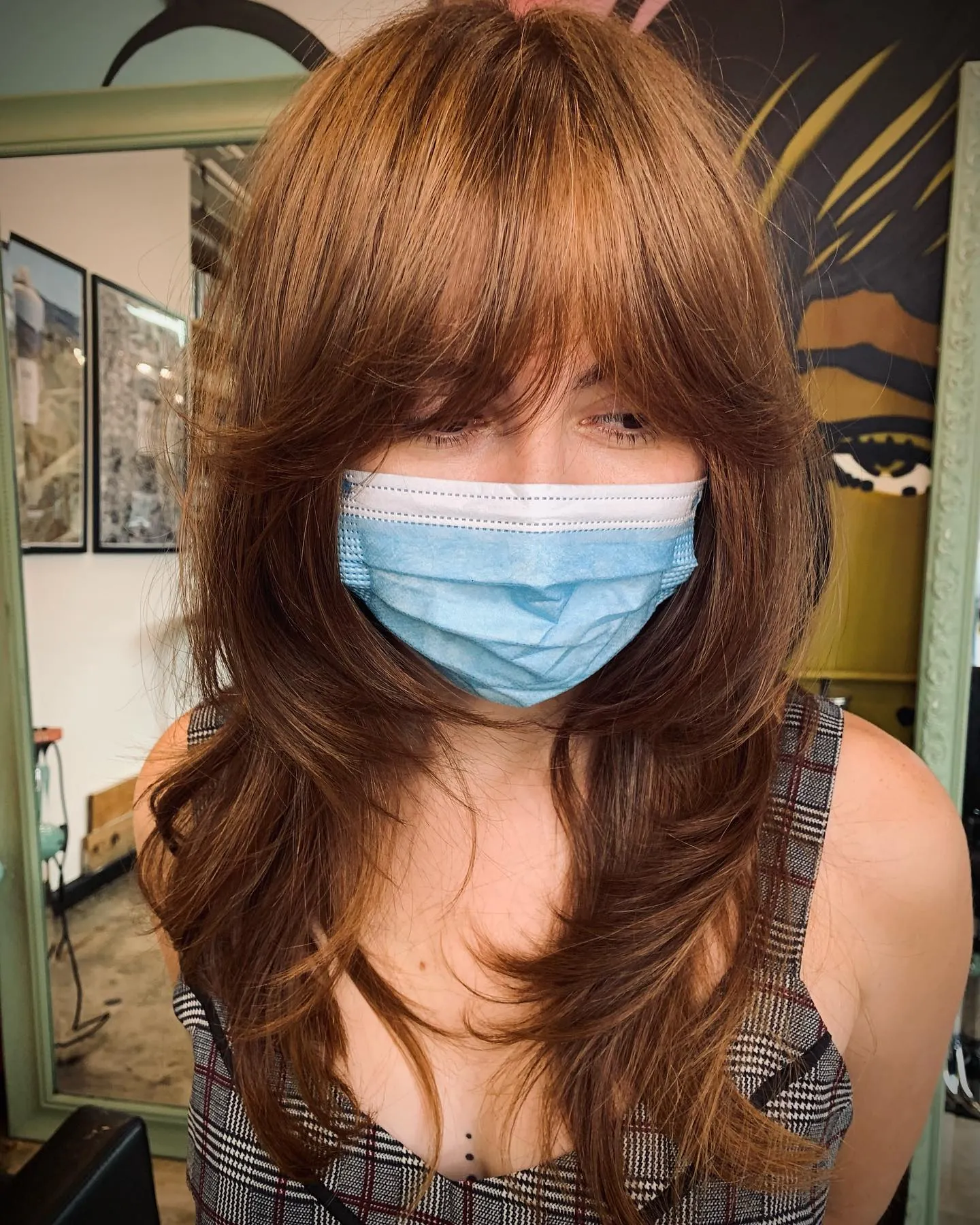 Long brown straight hair with curtain bangs and butterfly layers
