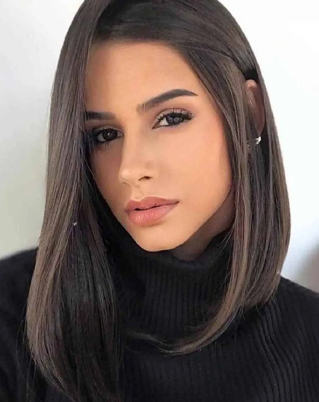 Dark straight lob with a deep side part and curved ends