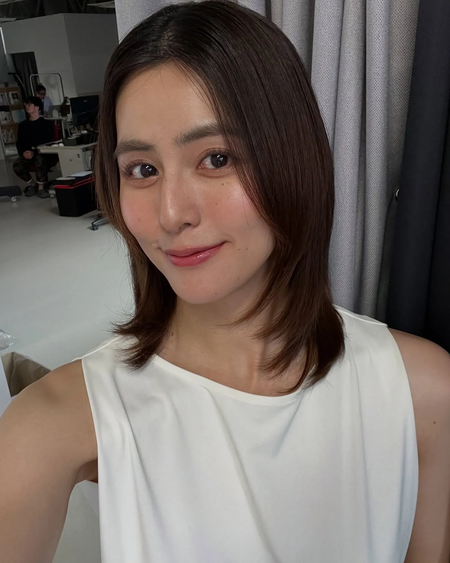 Brown shoulder-length straight hair with face-framing layers and flipped ends