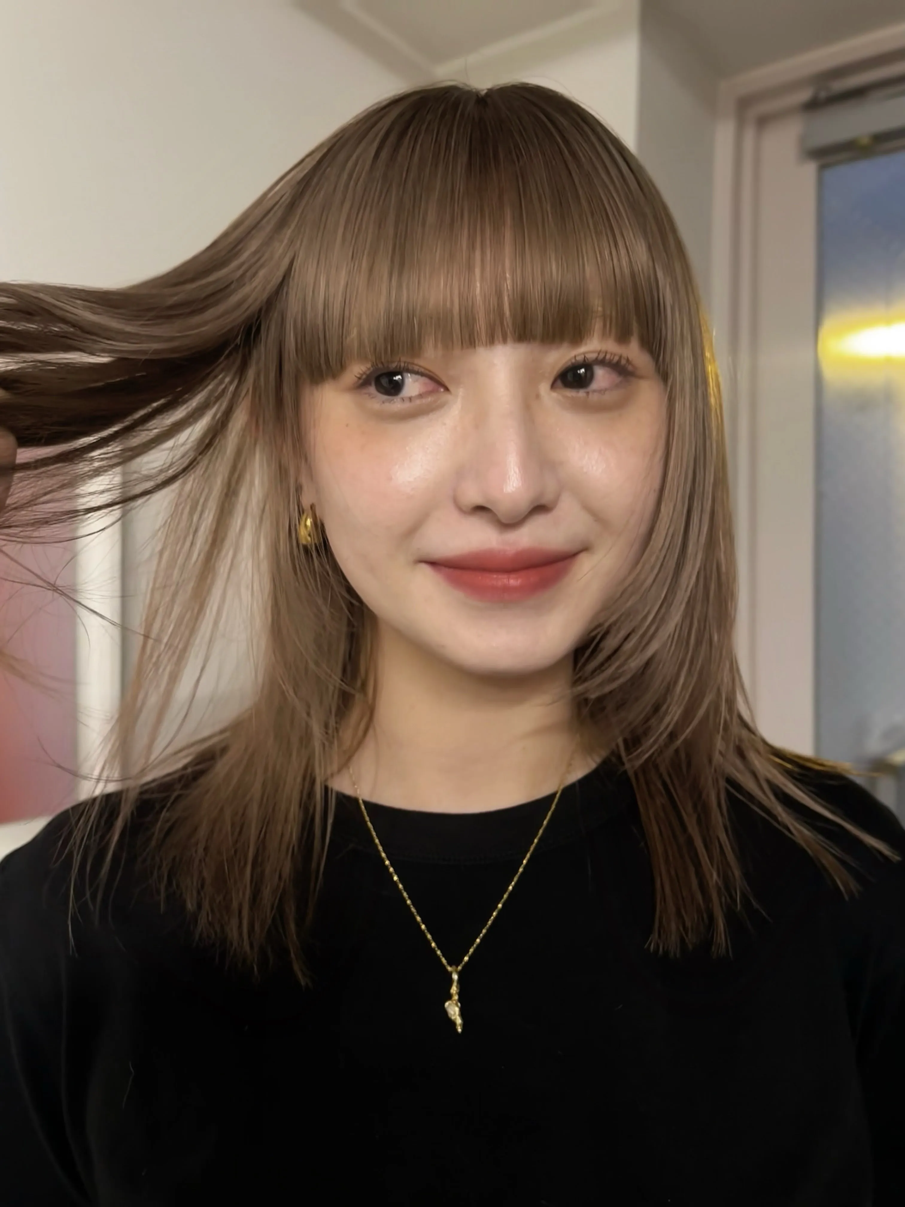 Light brown straight layered lob with blunt bangs