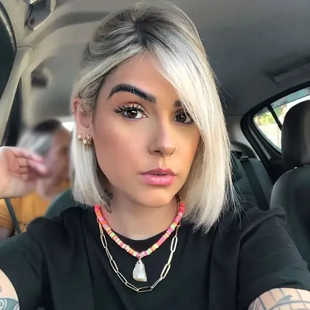 Short platinum straight bob with a deep side part