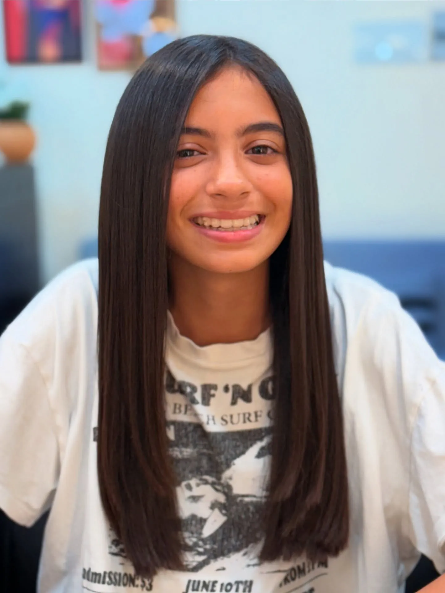 Long dark straight hair with a center part and blunt lower lengths