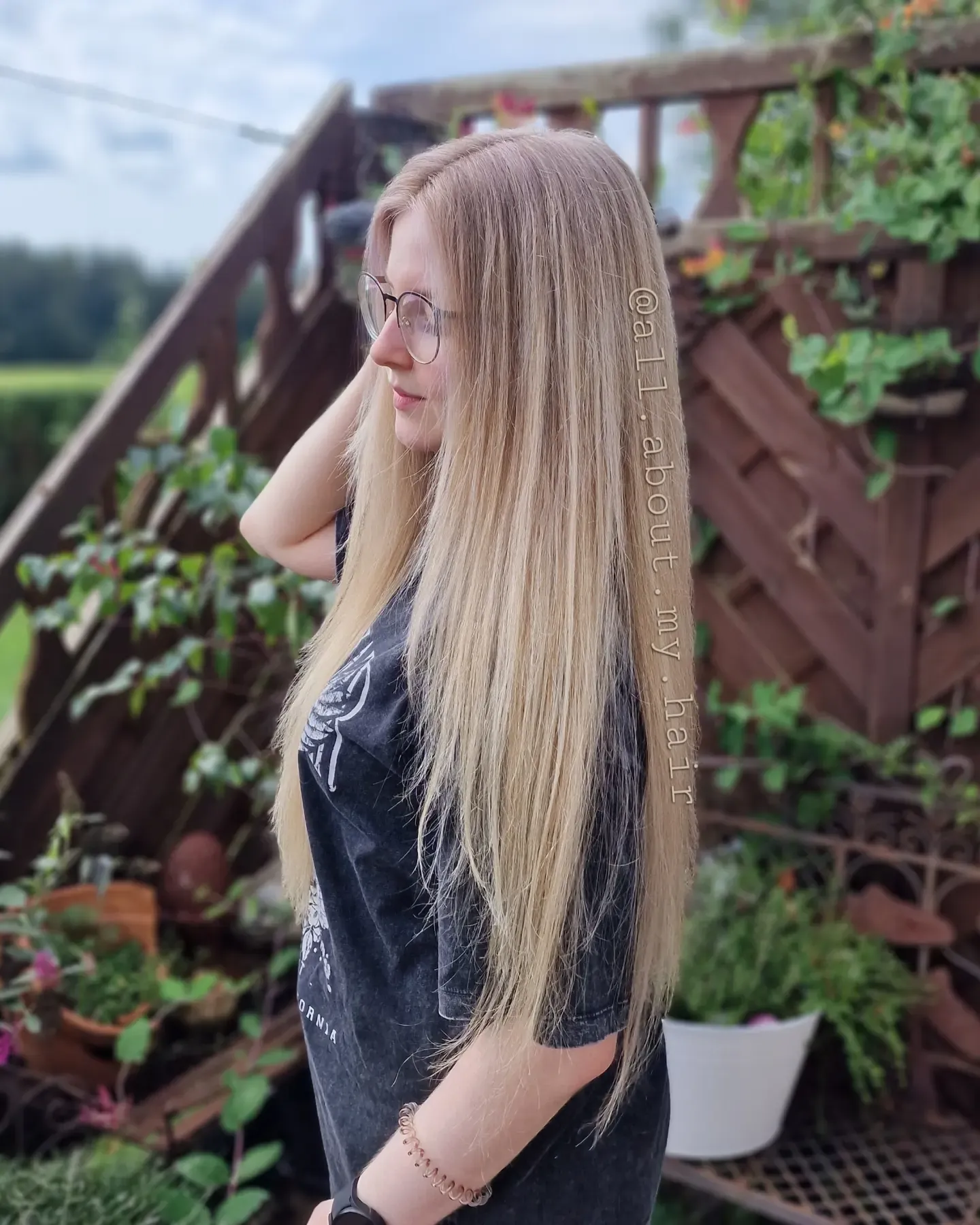 Very long blonde straight hair with a center part
