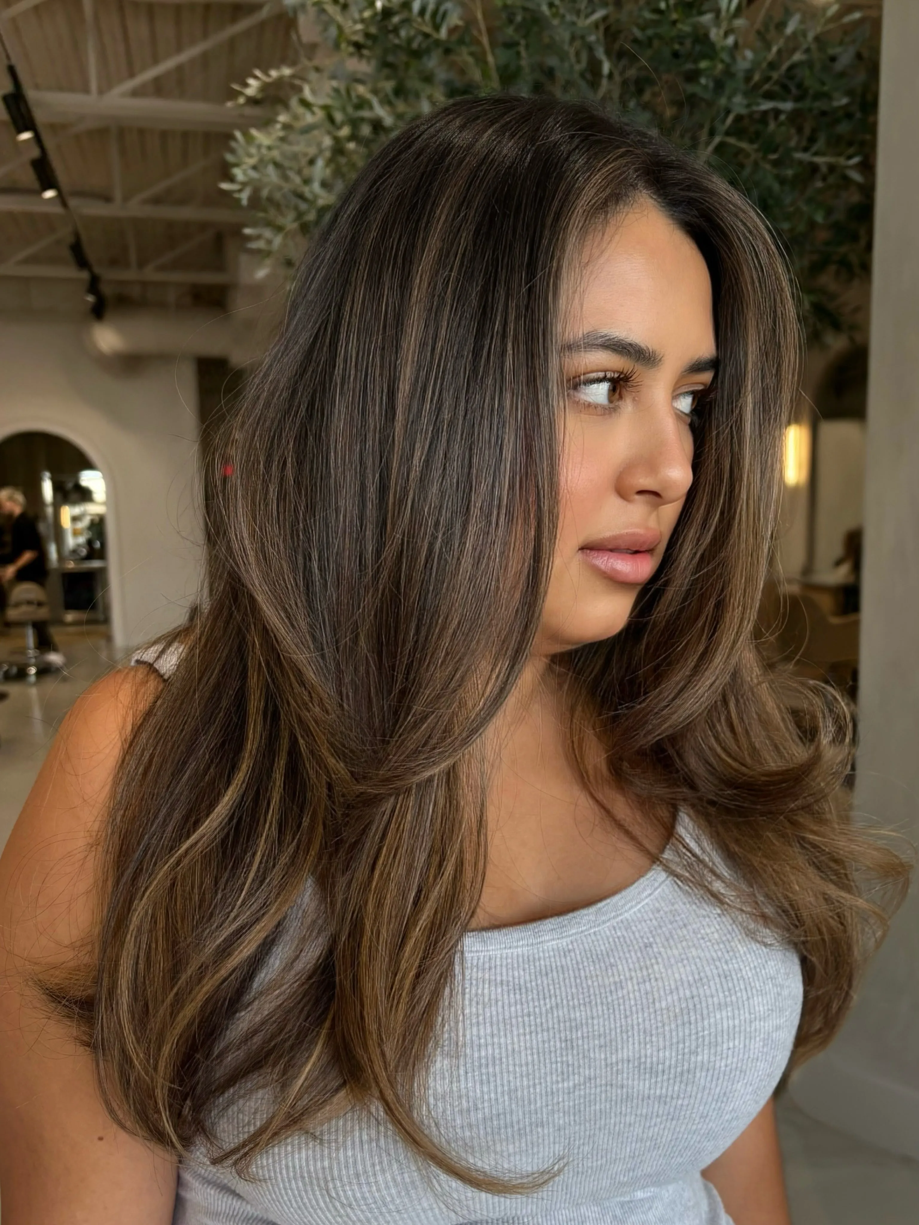 Long brunette blowout with voluminous face-framing layers
