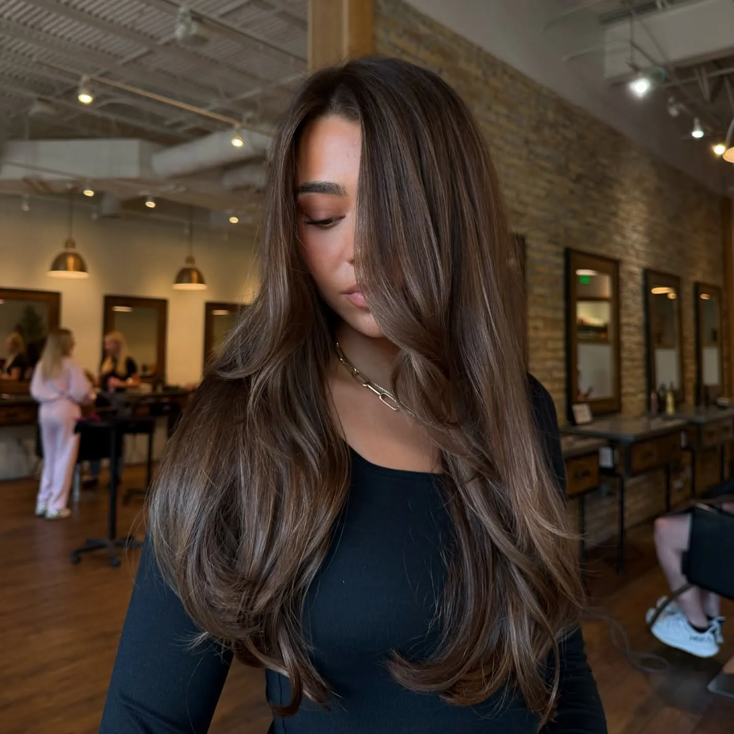 Long brunette waves with face-framing layers and centre part