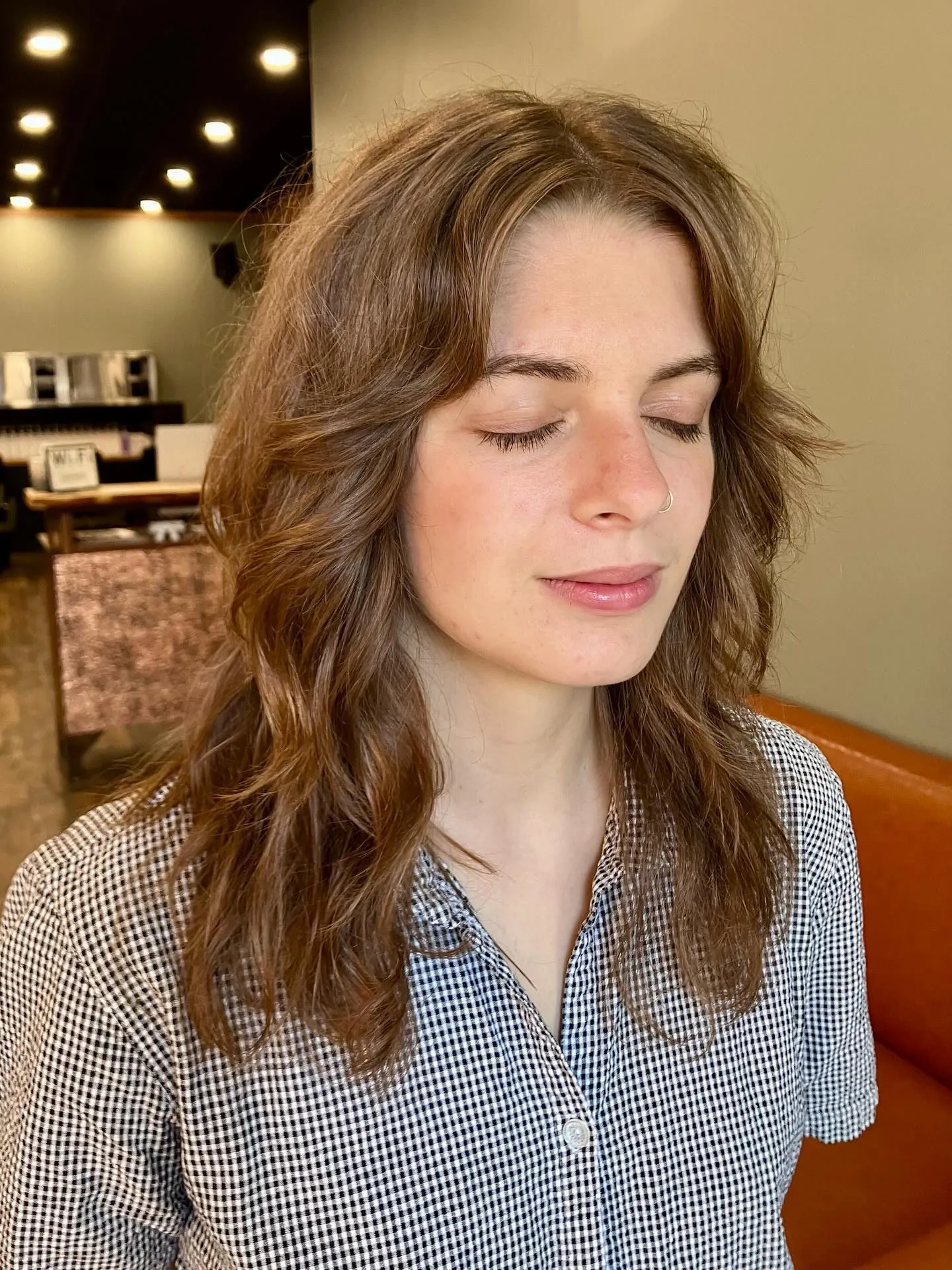 Shoulder-length wavy shag with face-framing layers and center part