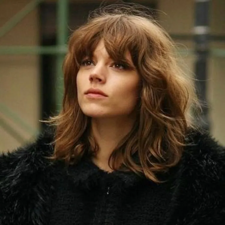 Medium wavy shag with full bangs and layered ends