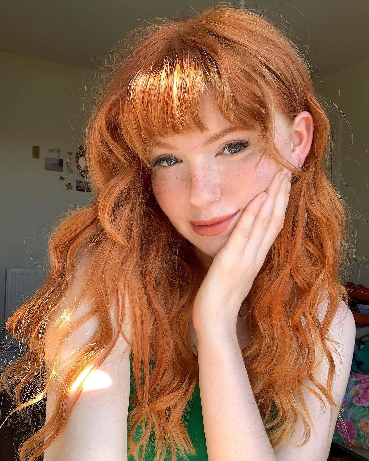 Long copper-toned waves with full straight bangs