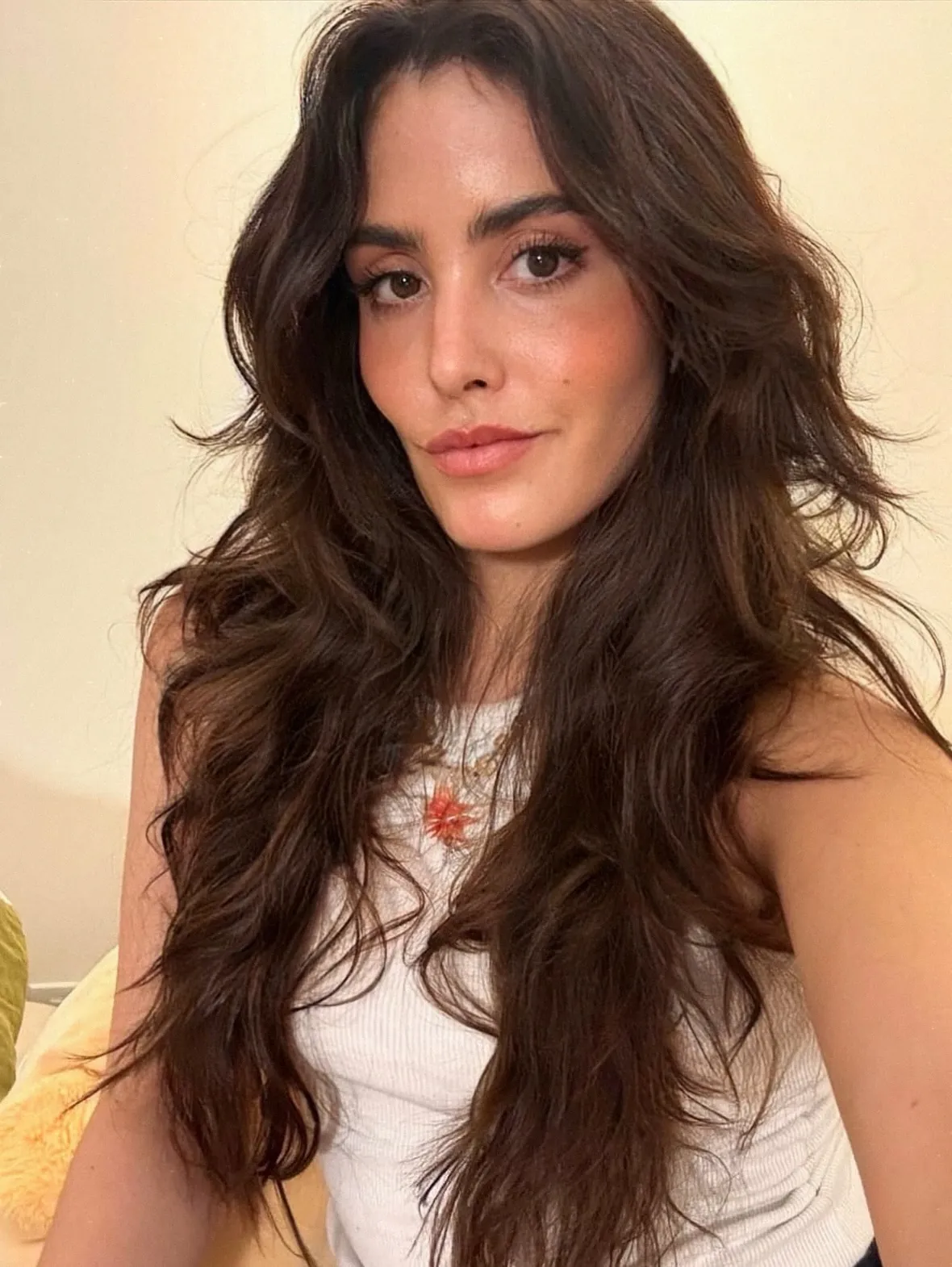 Long dark waves with face-framing layers and a center part