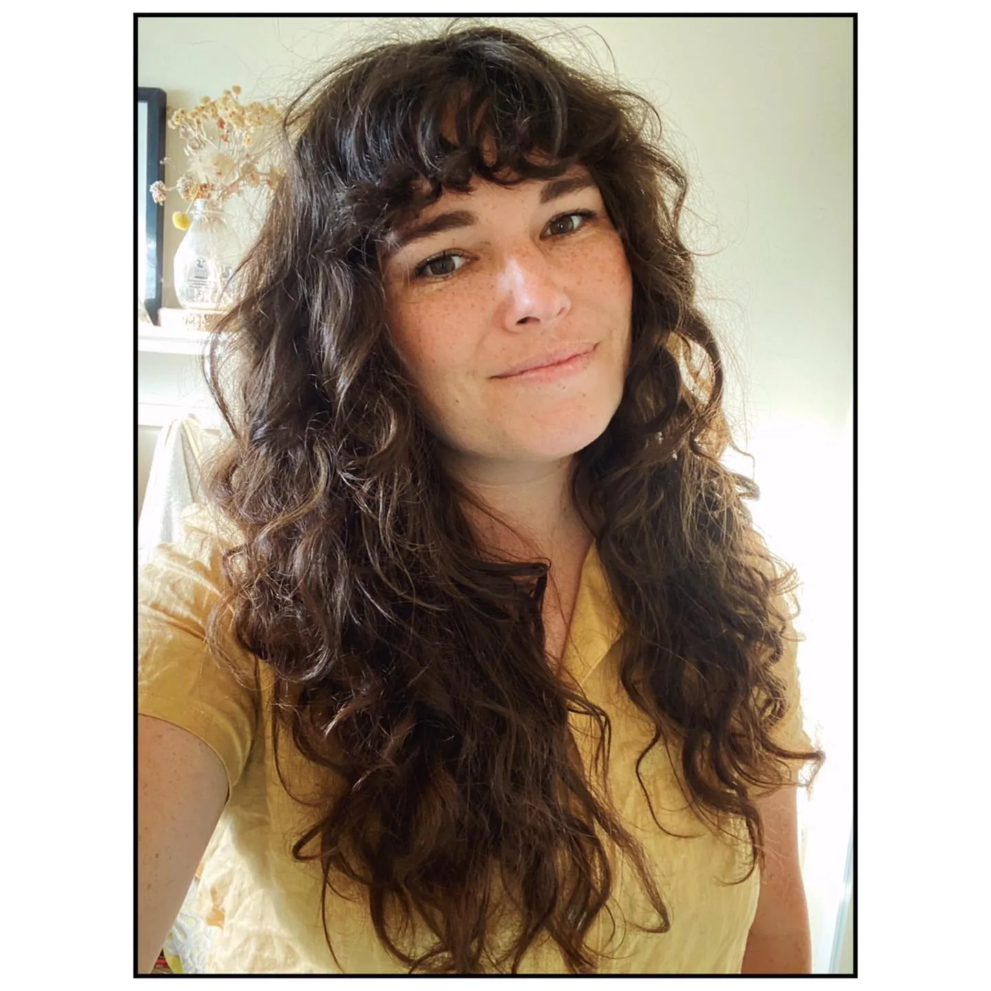 Very long dark waves with full curly bangs