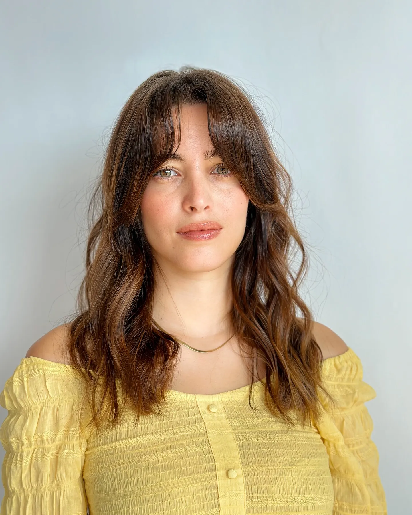 Medium brunette waves with a soft parted fringe