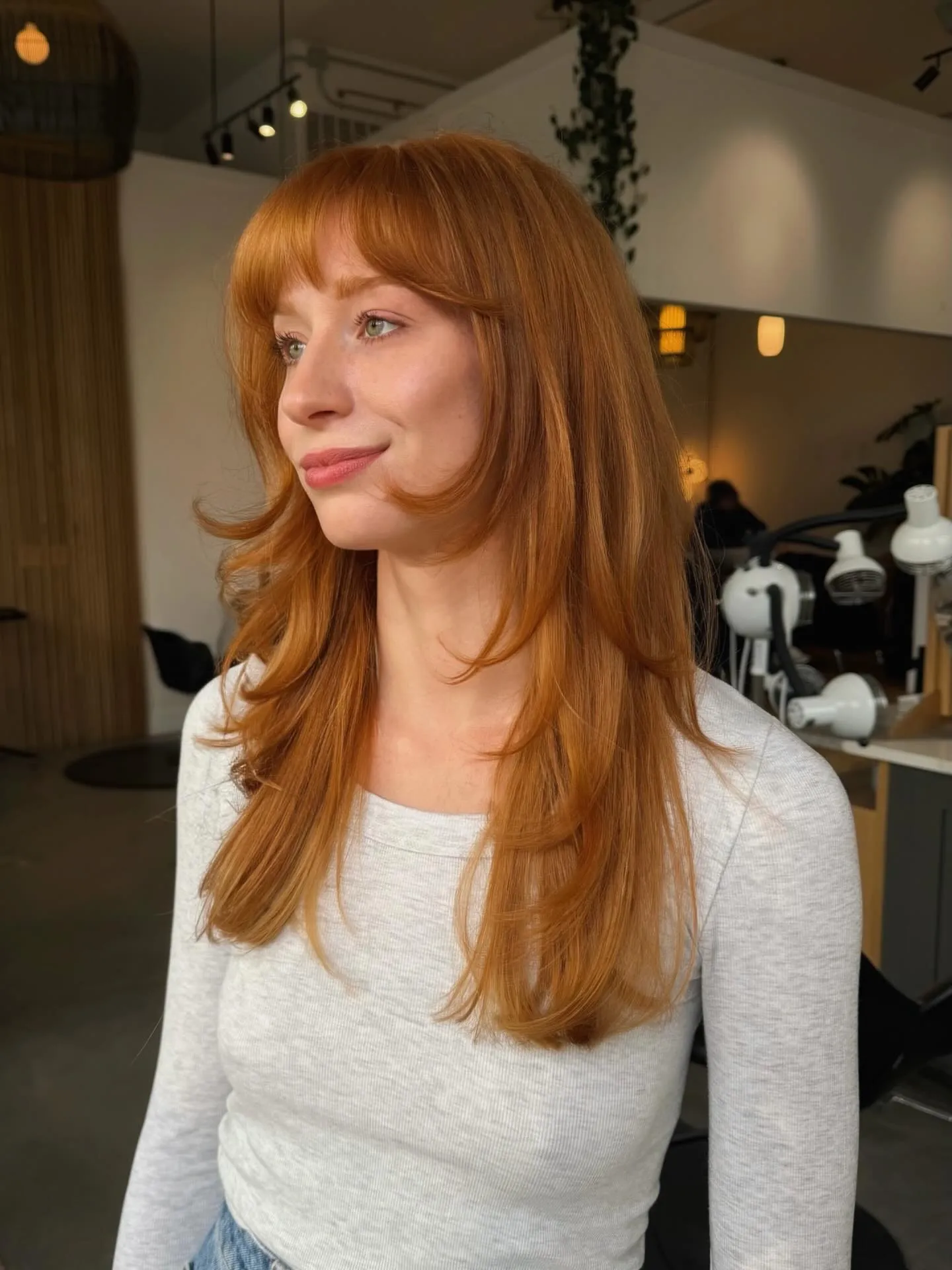 Long copper layers with full bangs and face-framing pieces