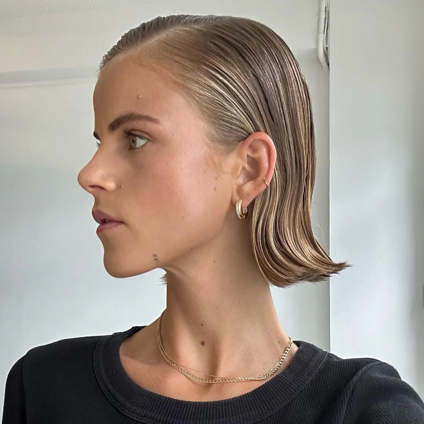 Sleek blonde bob with wet-look finish and flipped ends