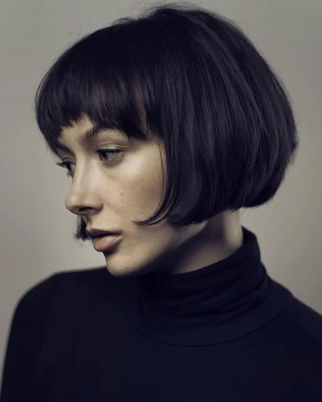 Dark rounded micro bob with short fringe and curved sides