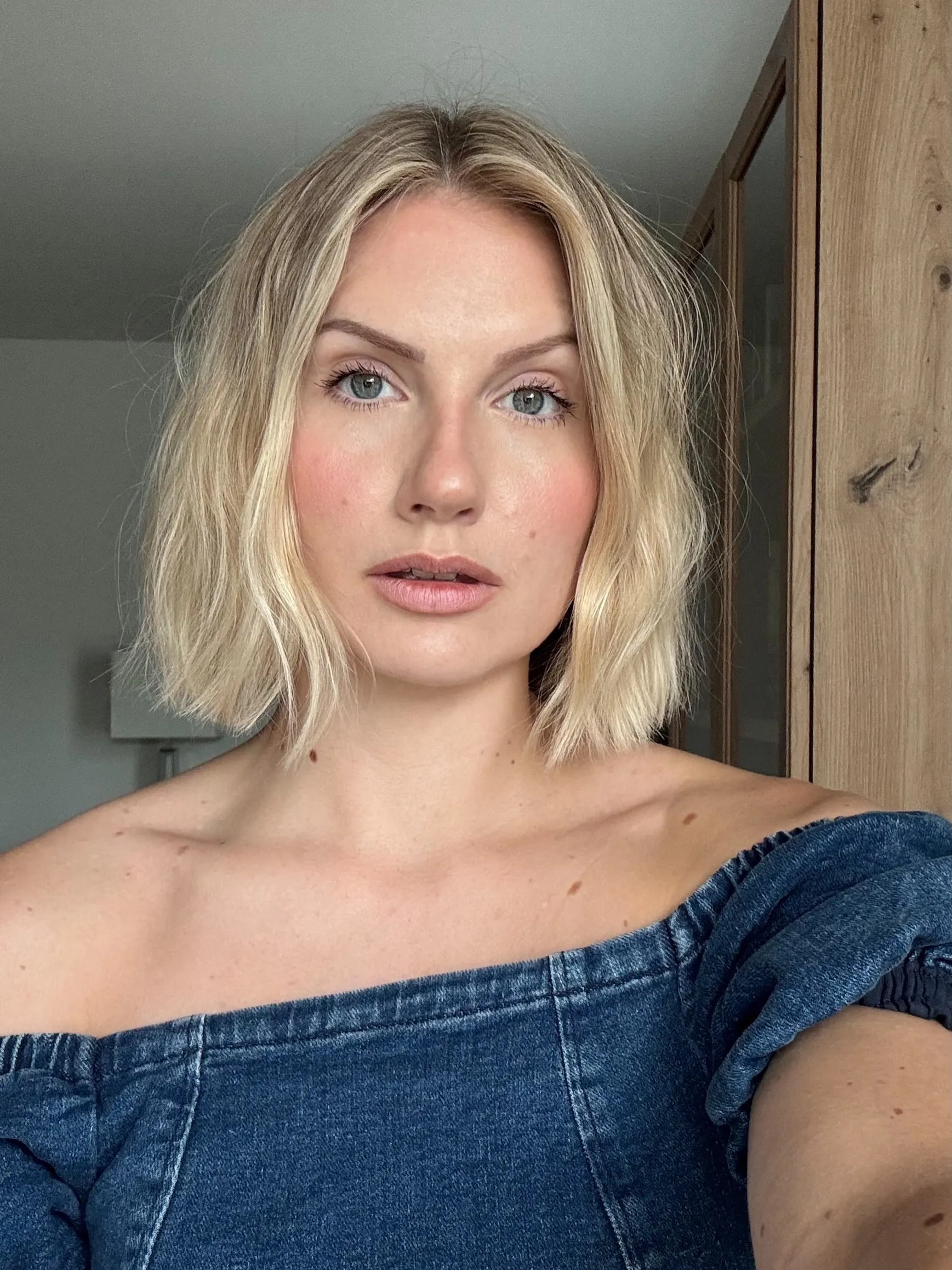 Tousled blonde bob with loose waves and flipped ends