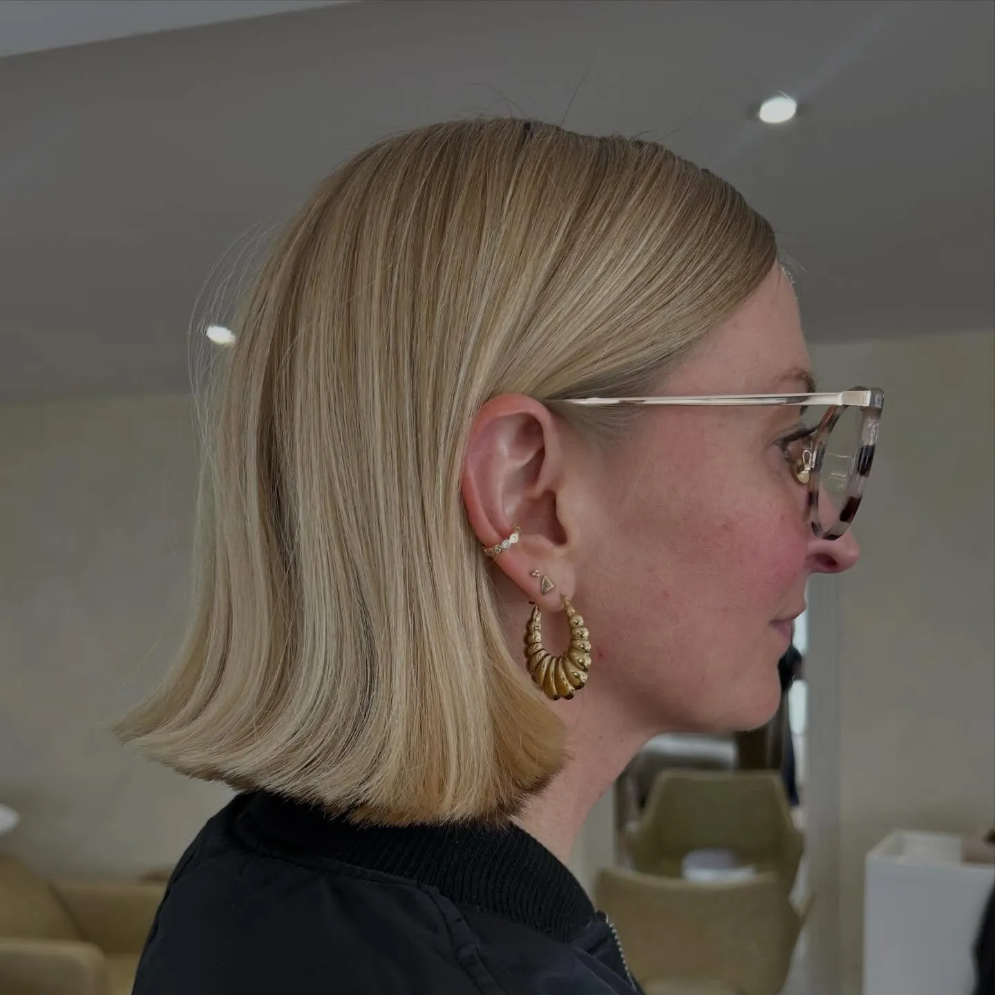 Blonde blunt bob with sleek side profile and flipped ends