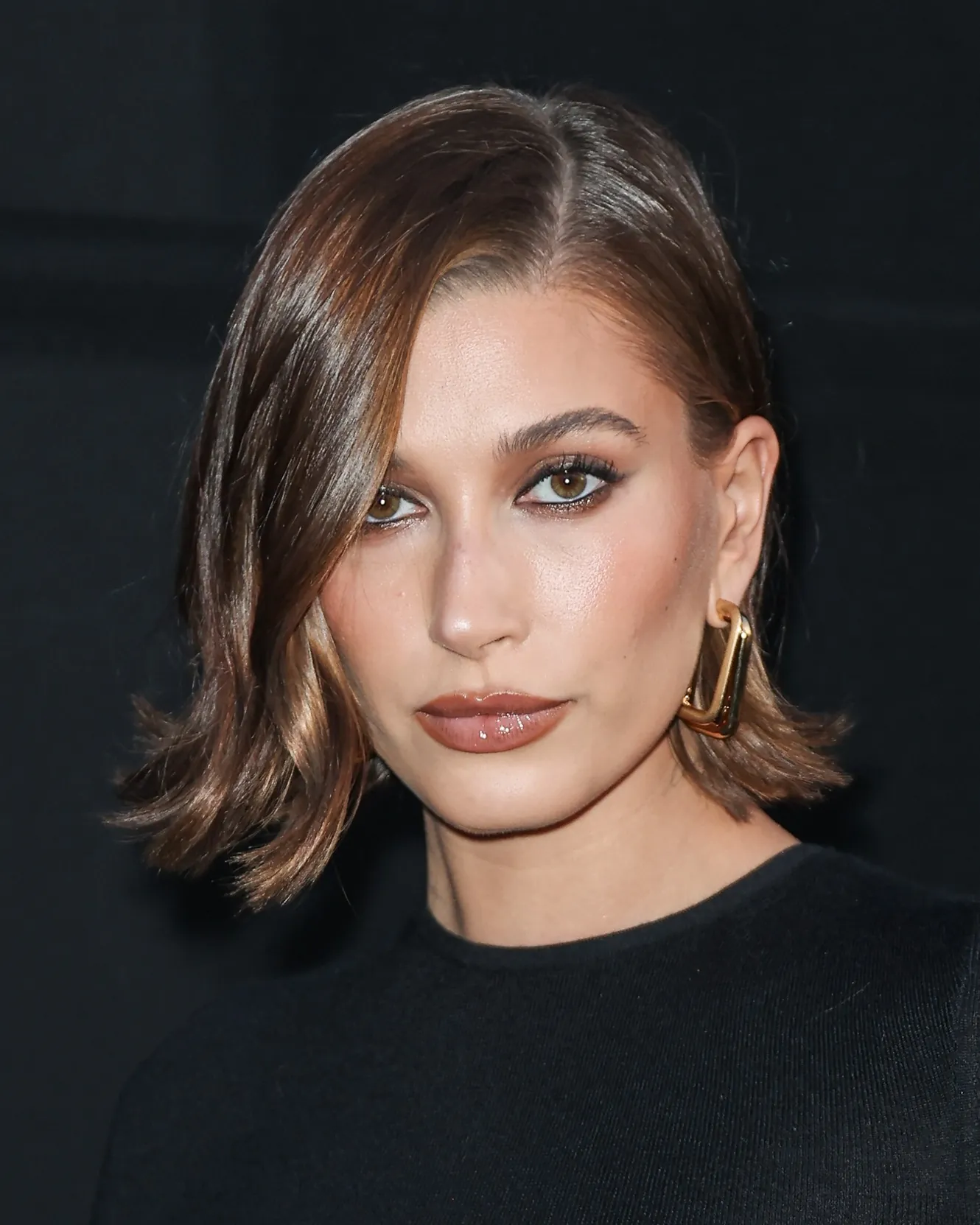 Short brunette side-part bob with sleek flipped ends