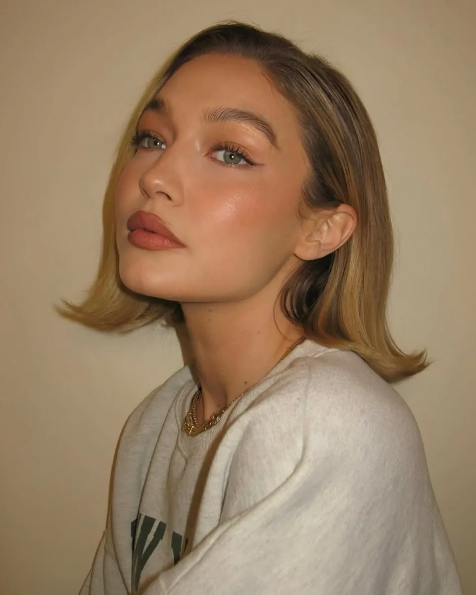 Soft blonde bob with side tuck and outward flipped ends