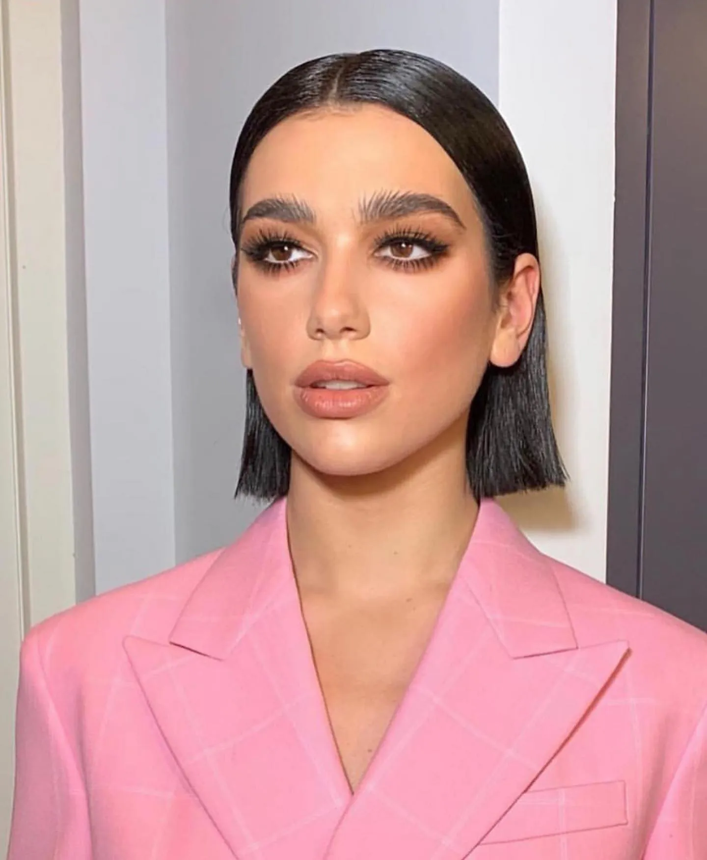 Sleek dark chin-length bob with center part