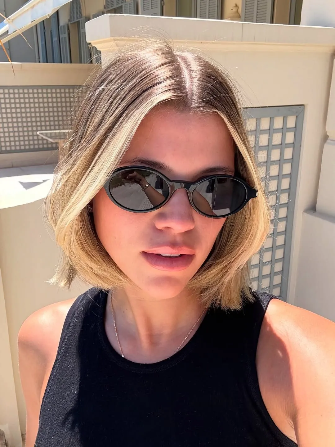 Blunt blonde bob with center part and straight ends