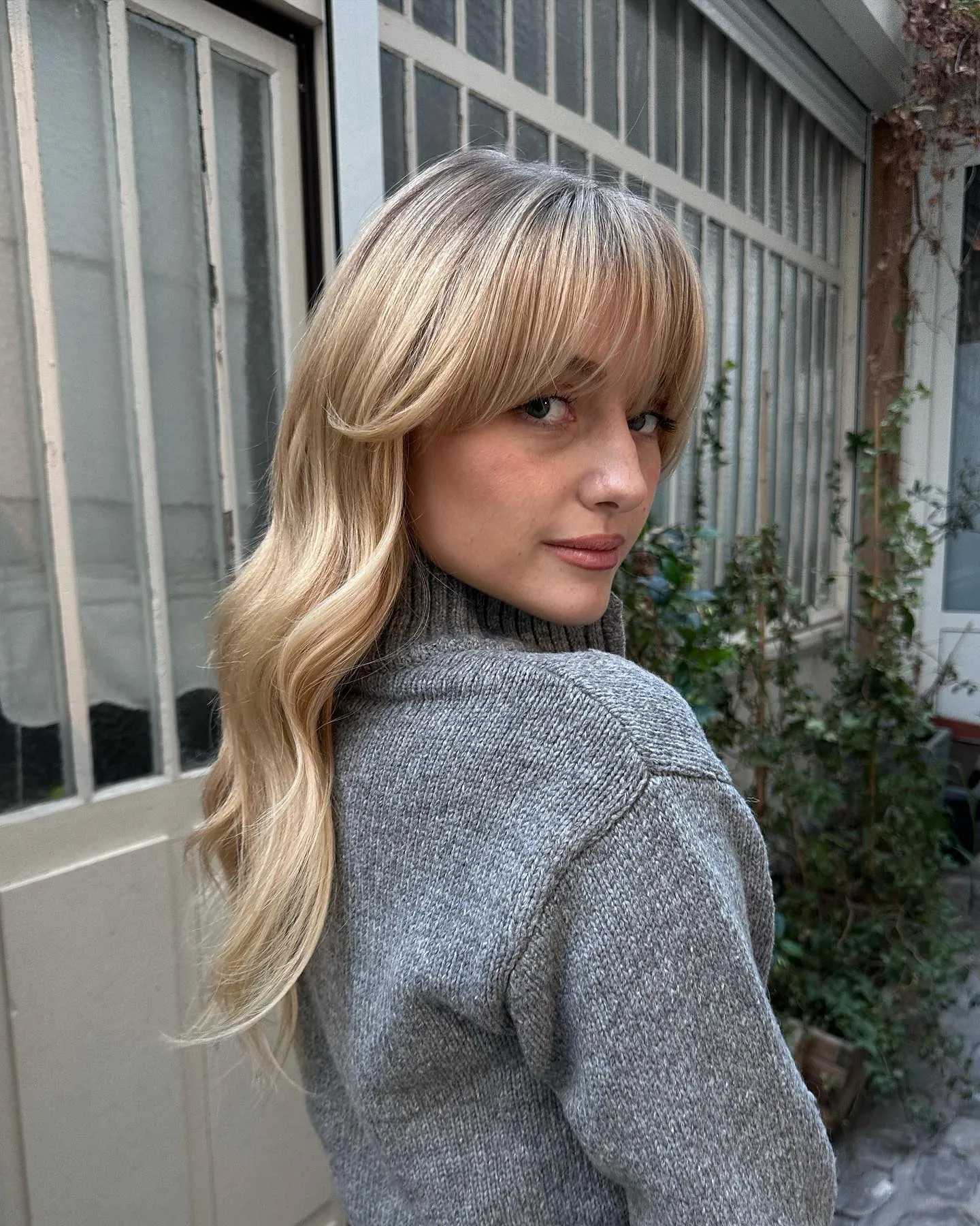Long blonde waves with full soft fringe