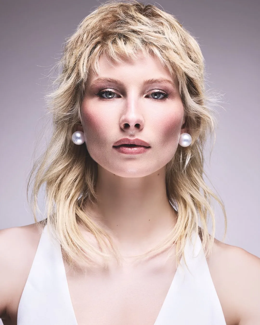 Blonde shag with choppy fringe and layered nape