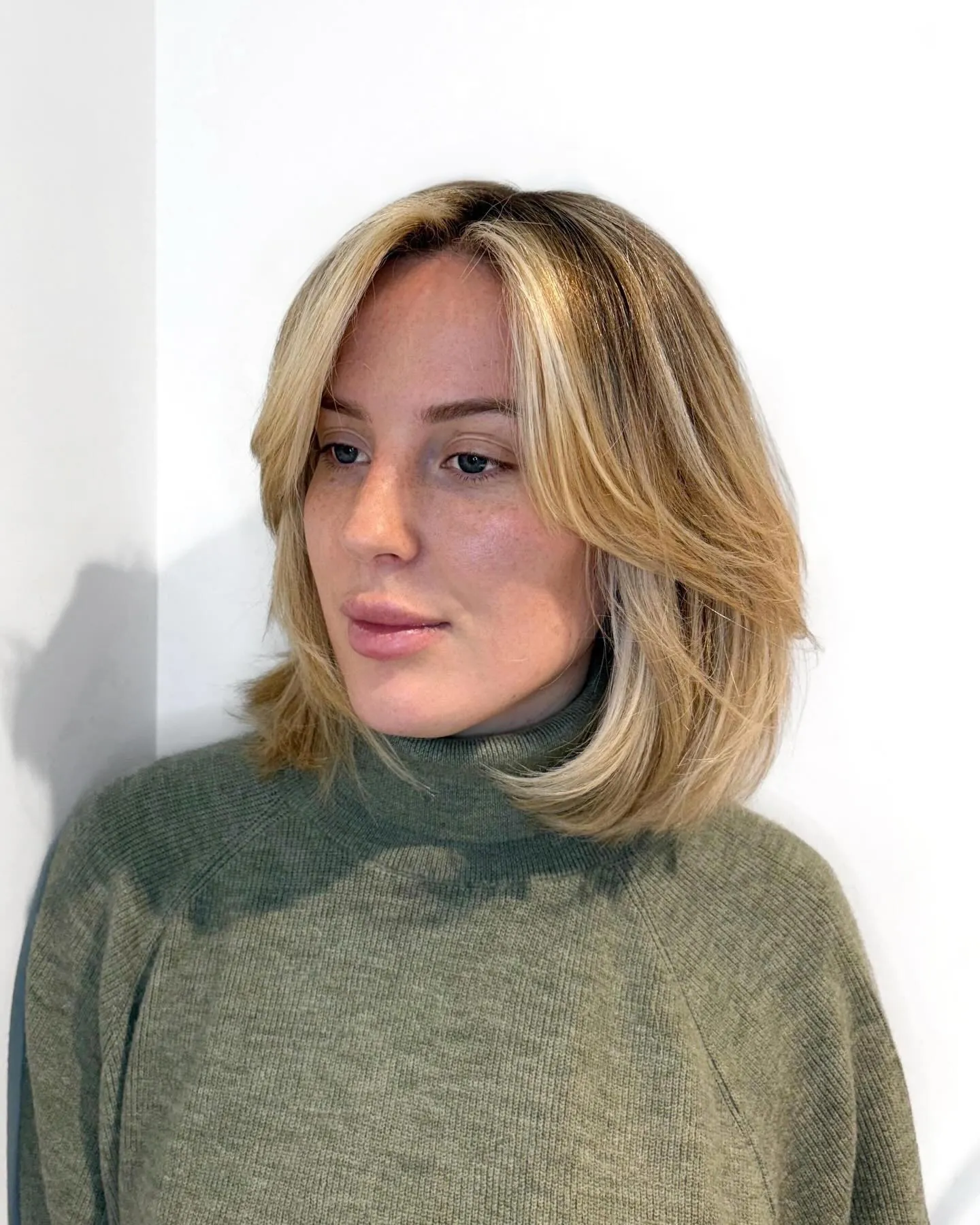Soft blonde lob with side-swept face framing