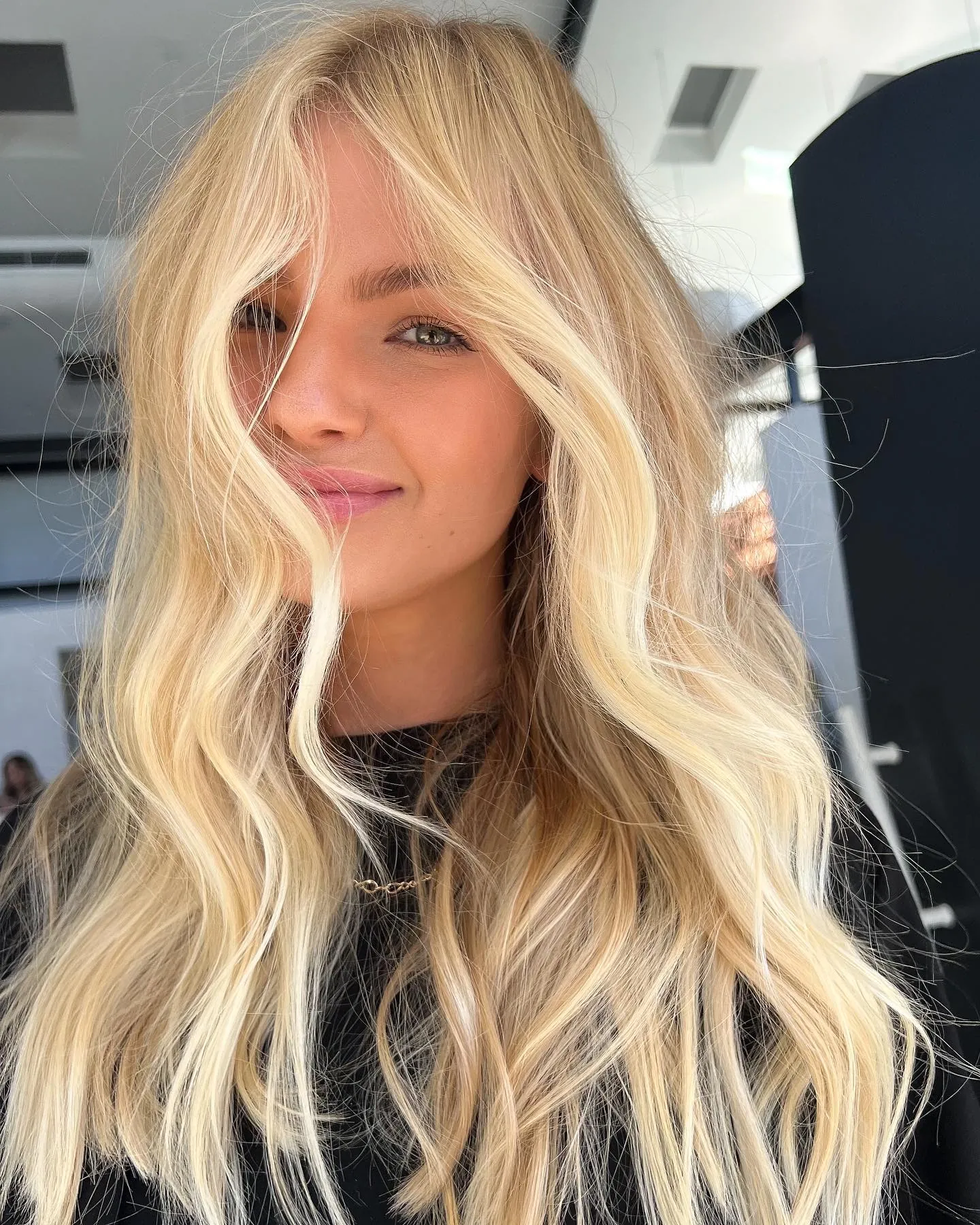Long blonde hair with loose center-part waves