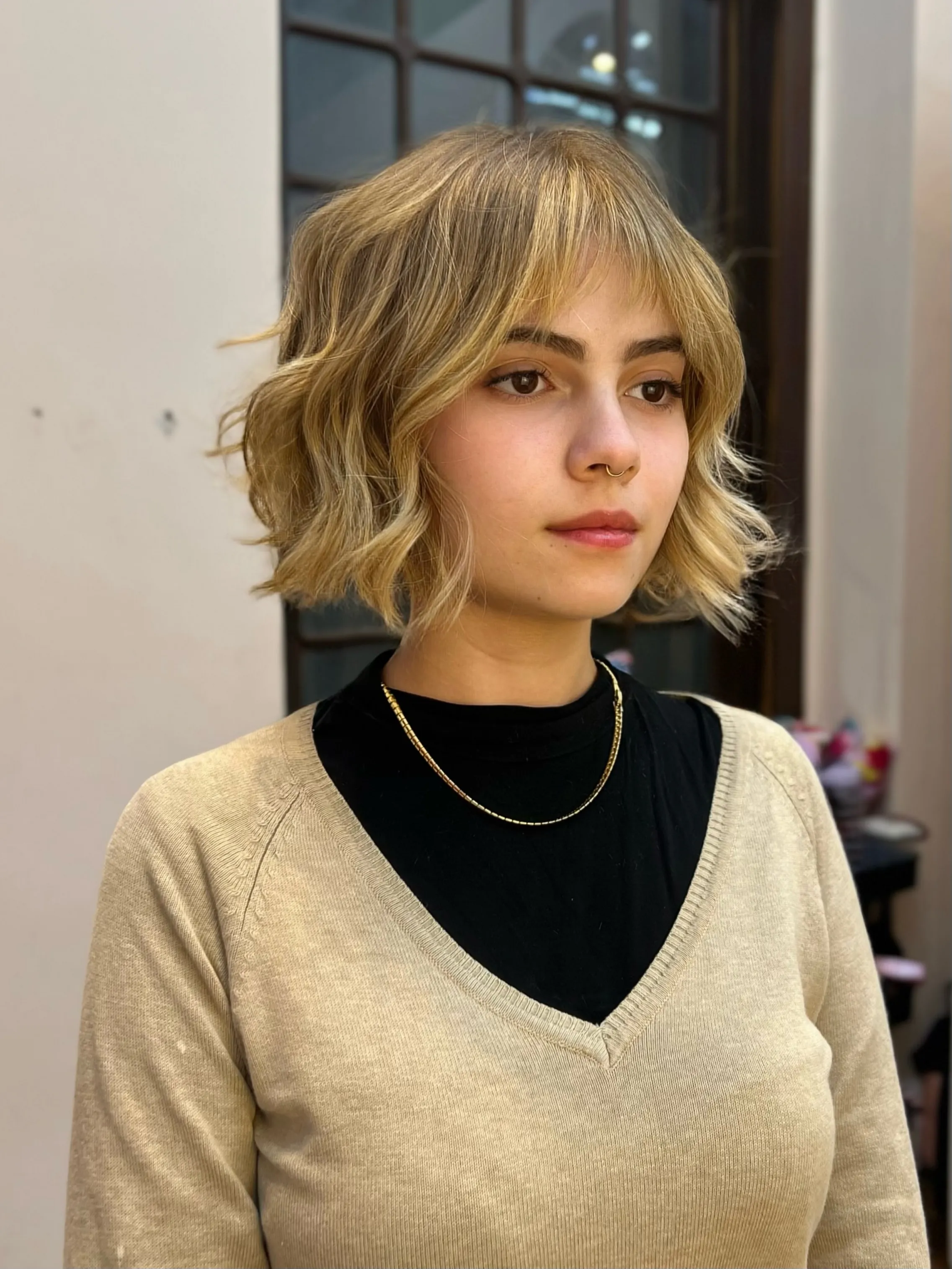 Wavy blonde bob with soft full fringe