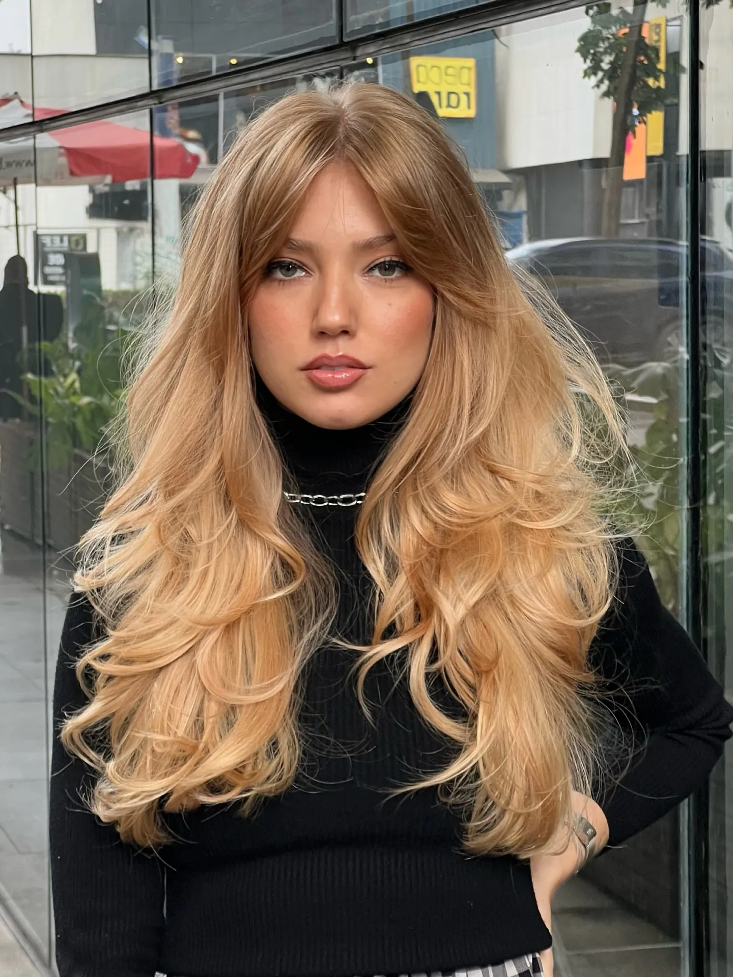 Long blonde hair with voluminous face-framing layers
