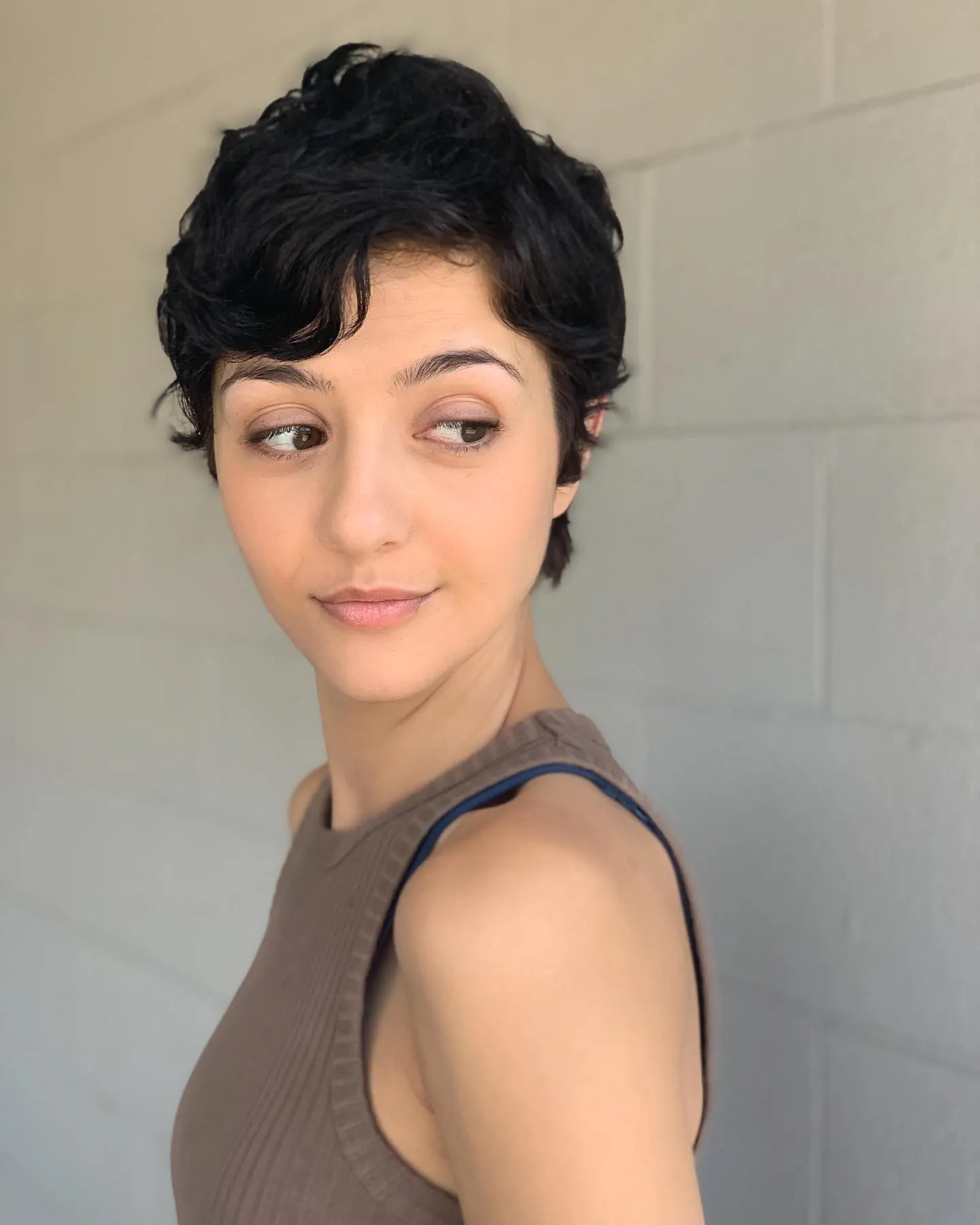 Dark wavy pixie with a soft side part