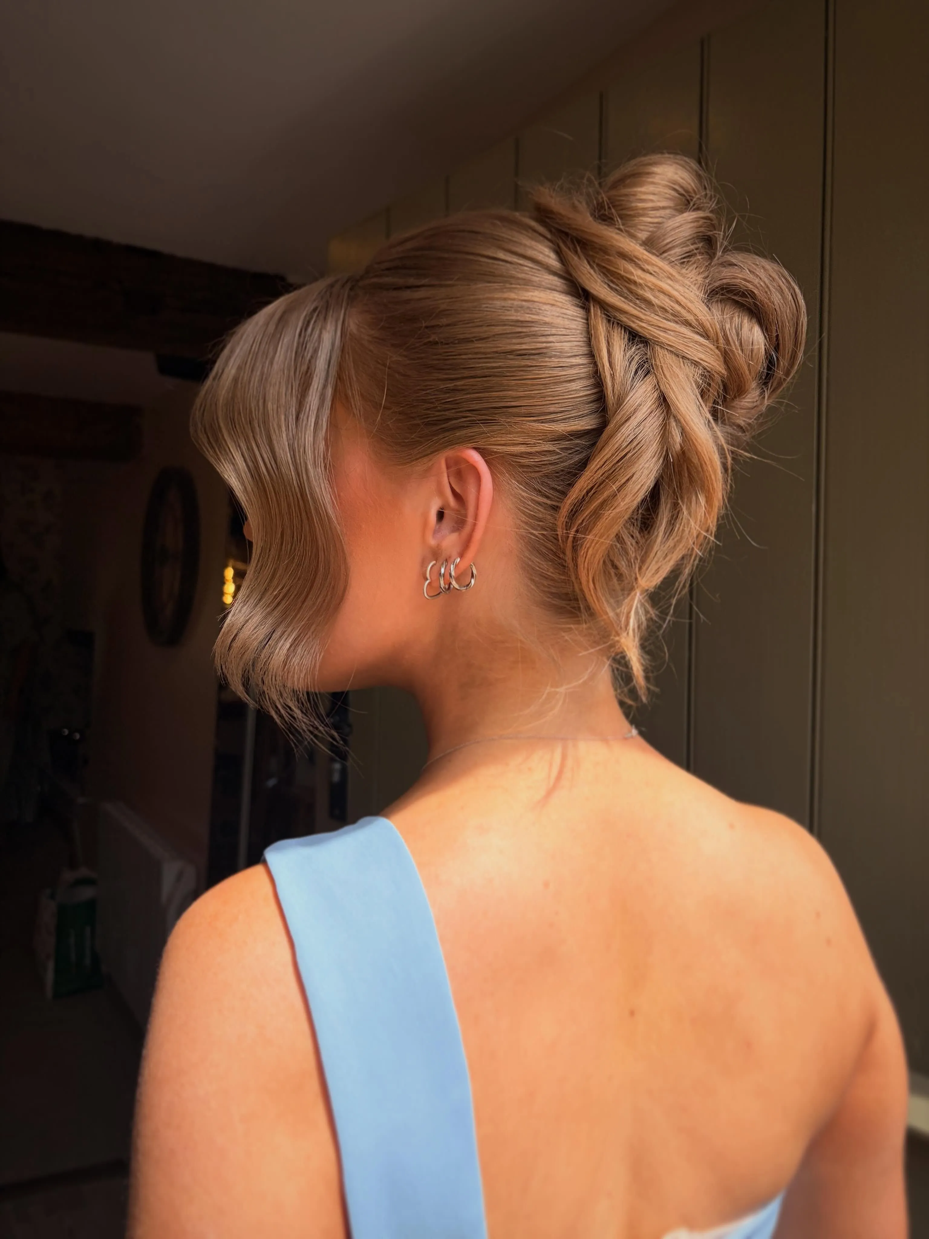 Tousled brunette French twist with loose pieces