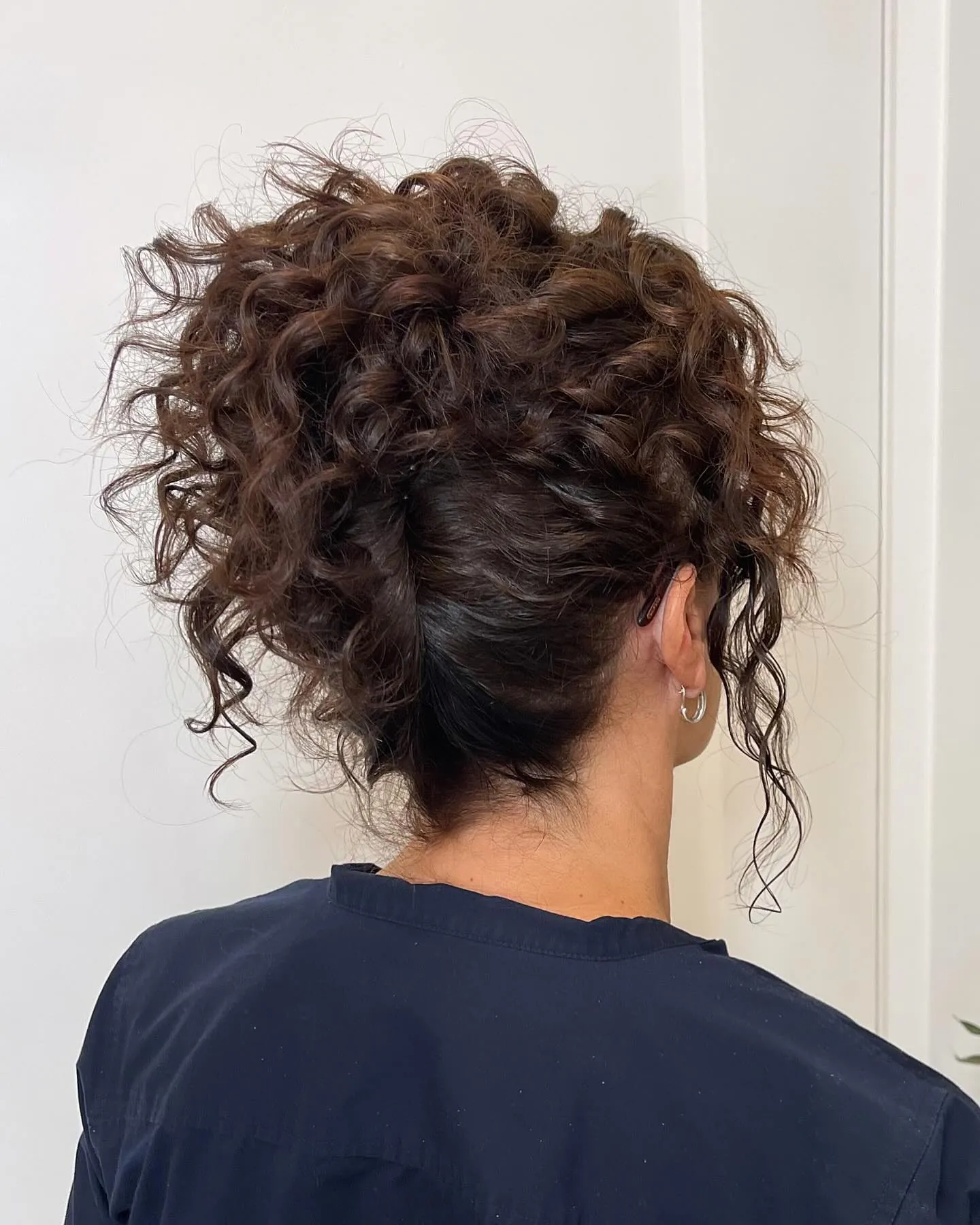 Curly dark French twist with natural texture