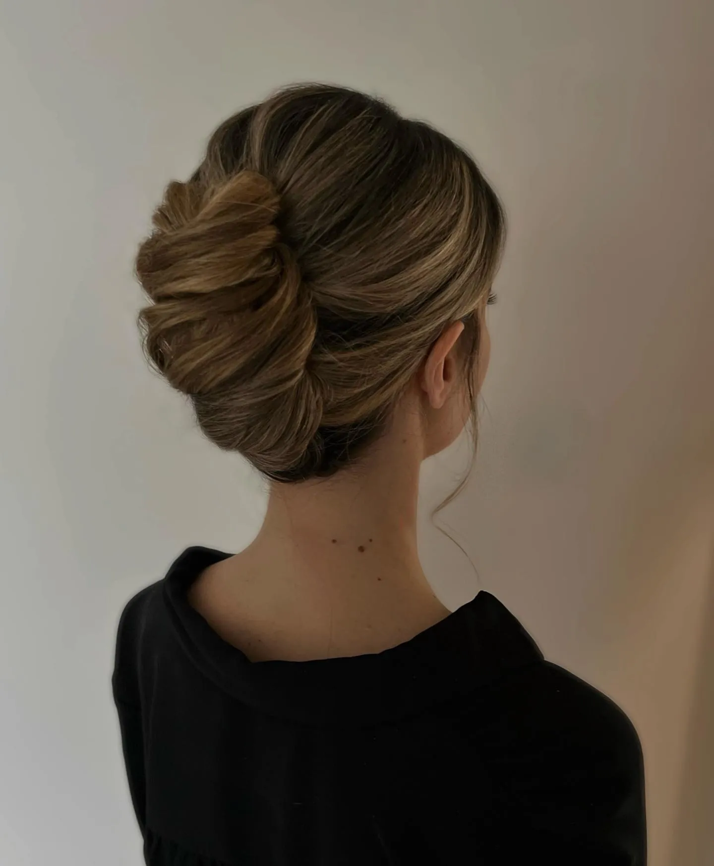 Low blonde French twist with pleated folds