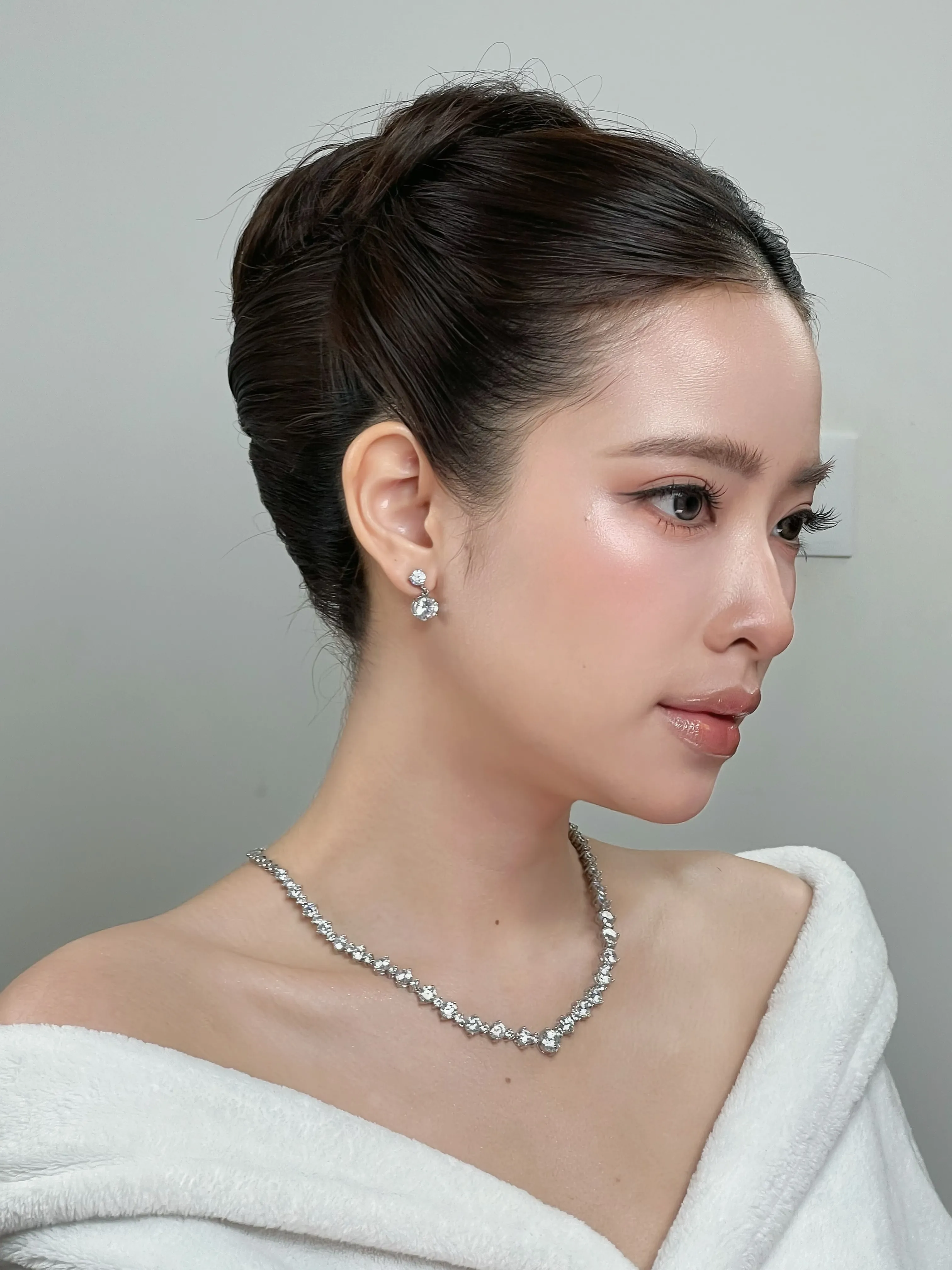 Sleek dark French twist viewed from the side
