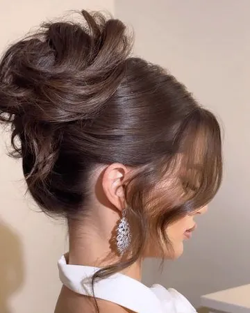 Voluminous brunette French twist with lifted crown