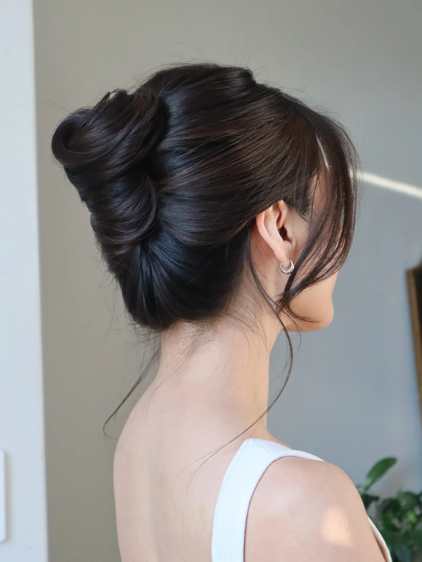 Sleek dark French twist with high polished roll